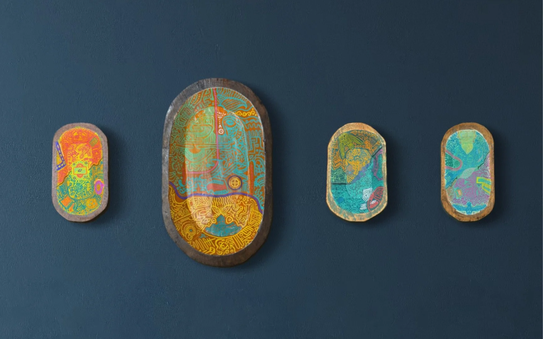 Four decorative oval wooden dough bowls with colourful, intricate tribal patterns, arranged in a row from smallest to largest.
