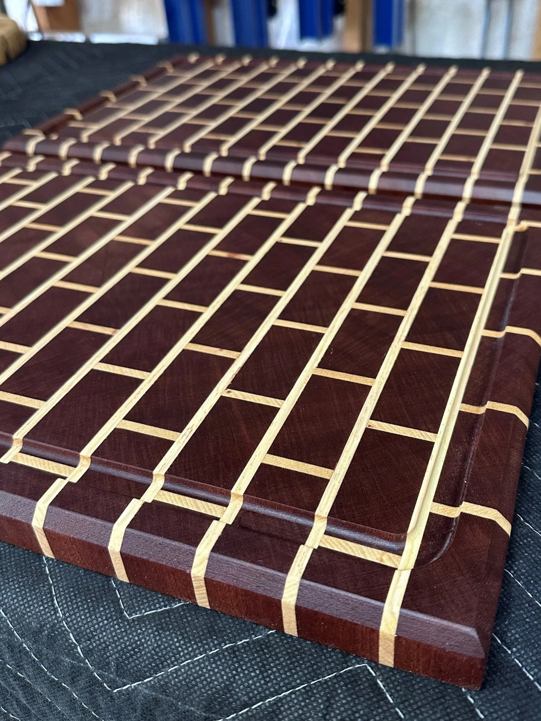 Close-up of a cutting board showing a brick pattern created an alternating dark and light wood strips.