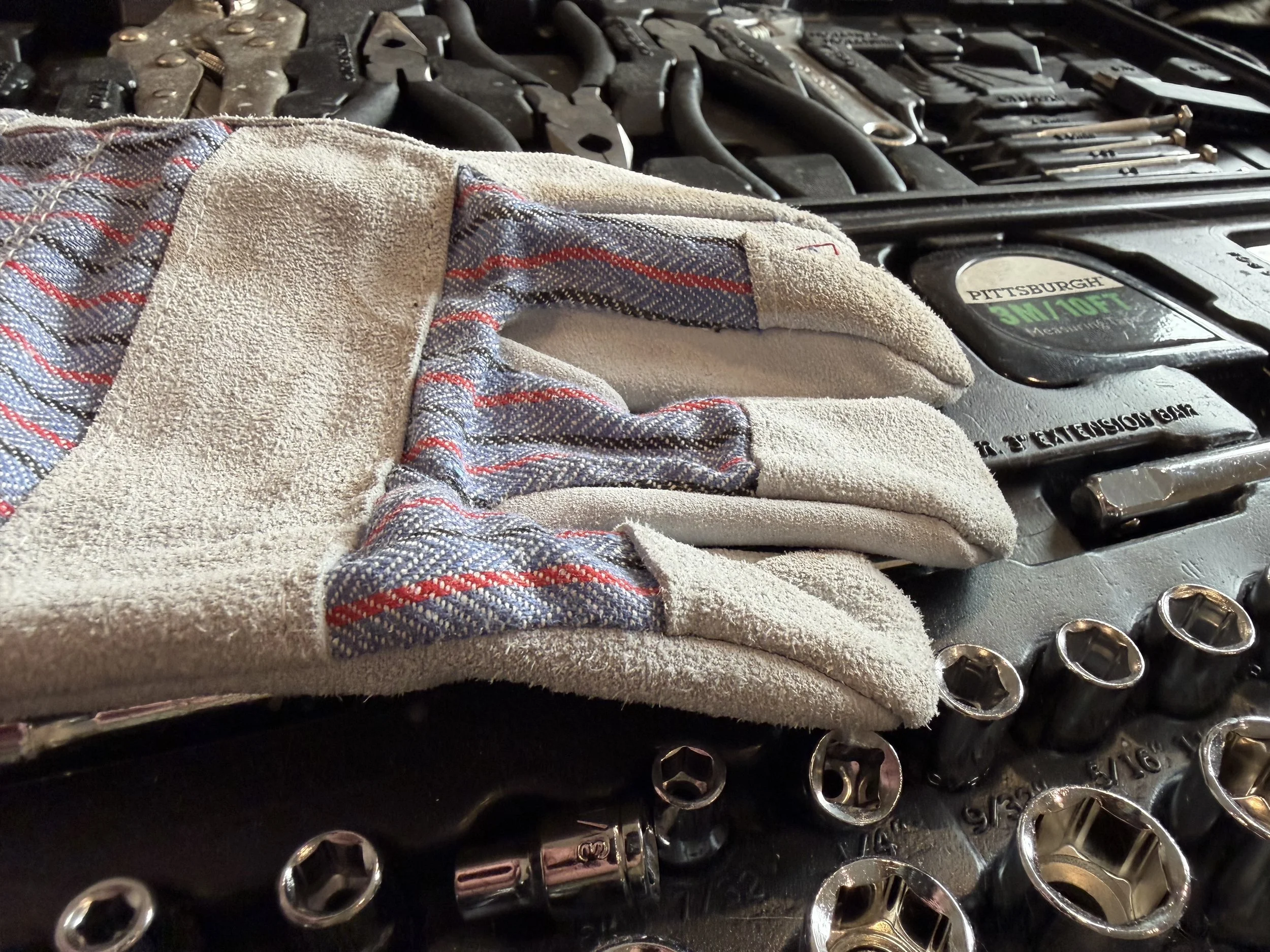 An open professional tool kit featuring a comprehensive set of wrenches and precision drivers used by SLLET Solutions for technical furniture assembly and equipment installation.