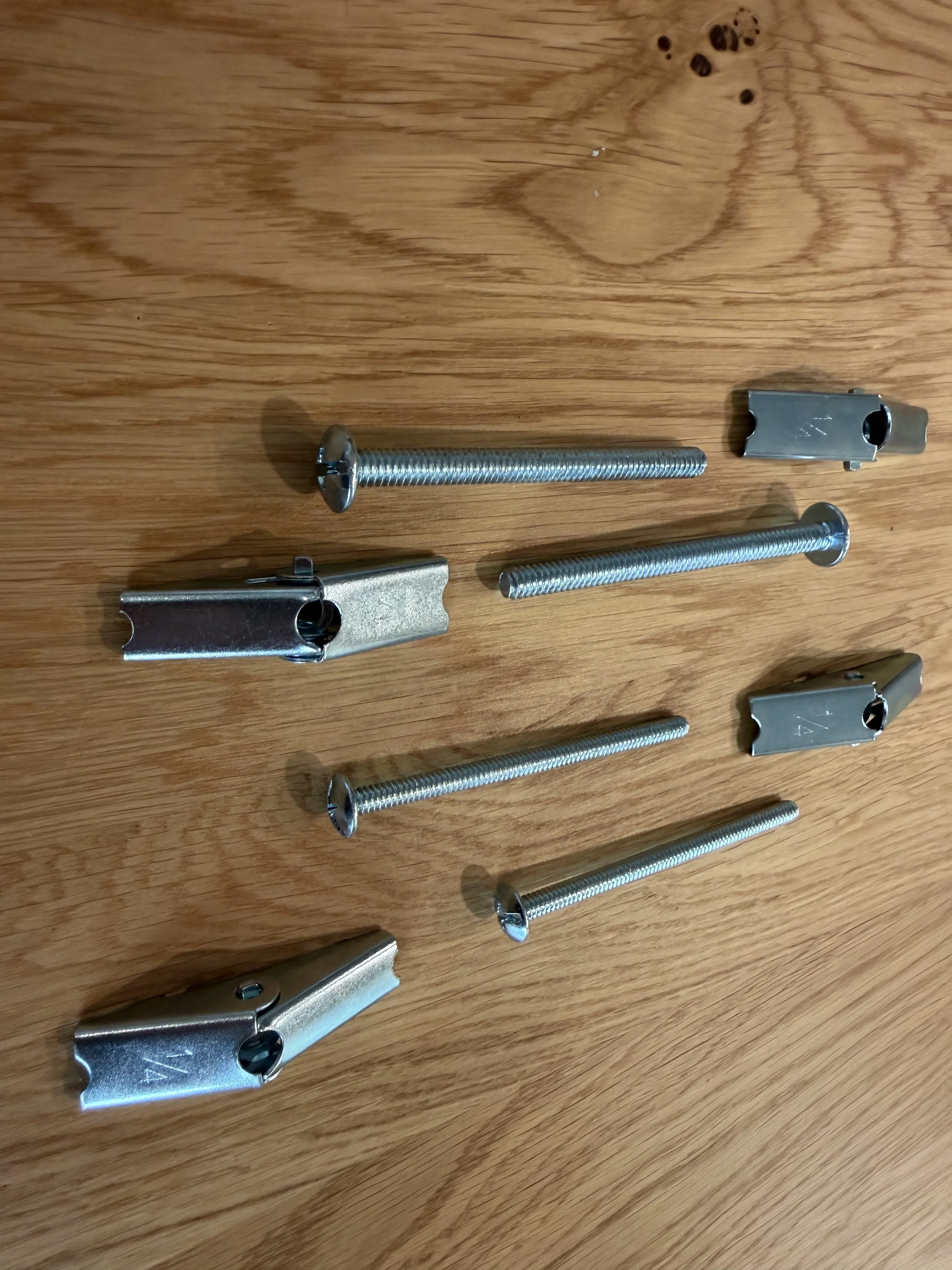 Organized inventory of modular office system hardware and mounting components staged for a technical workspace configuration by SLLET Solutions.