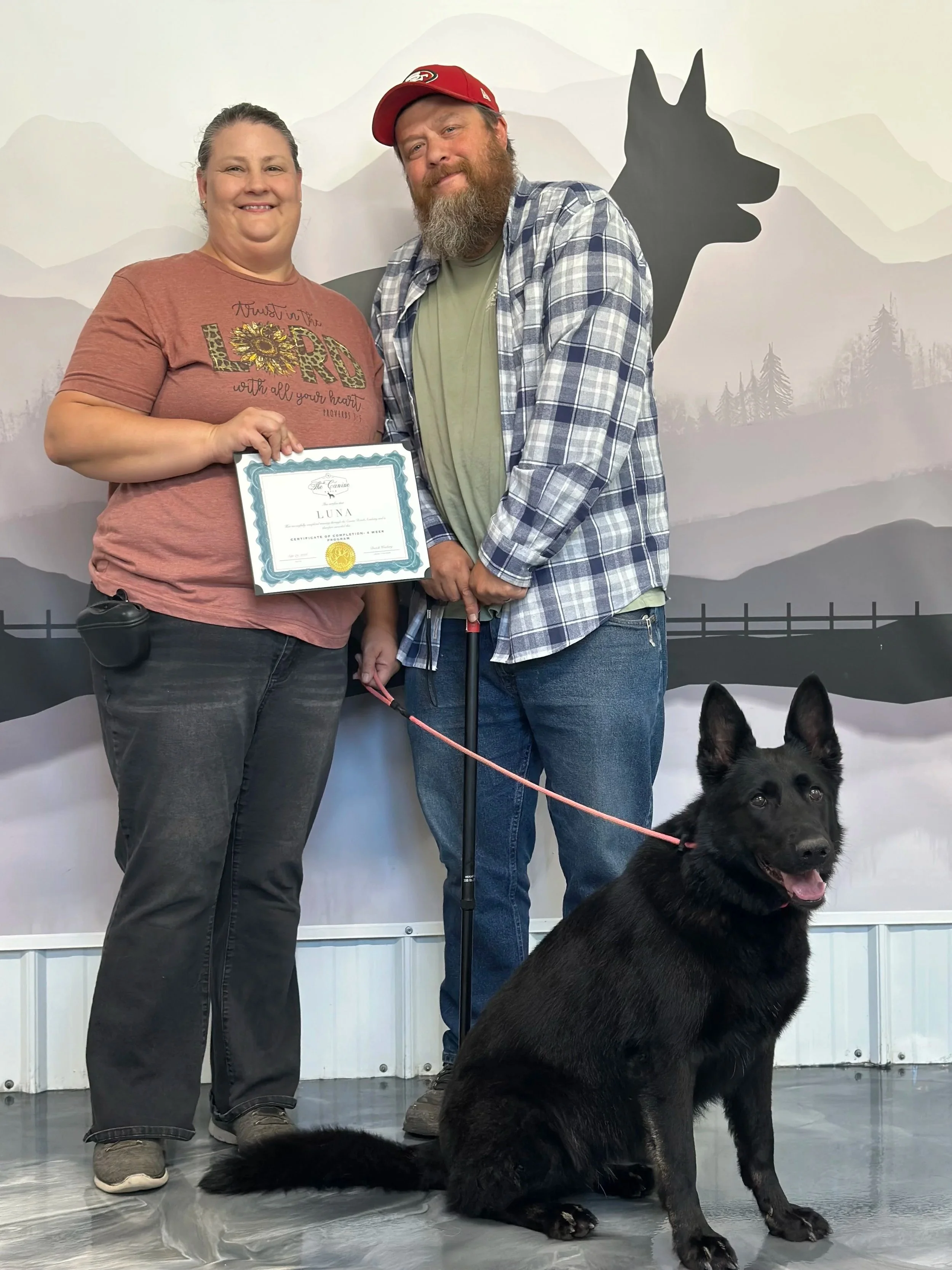 Black German Shepherd Luna graduating from a 4-week board and train program with improved behavior, obedience and reliable off leash recall. Behavior Modification Training. Off-Leash recall.