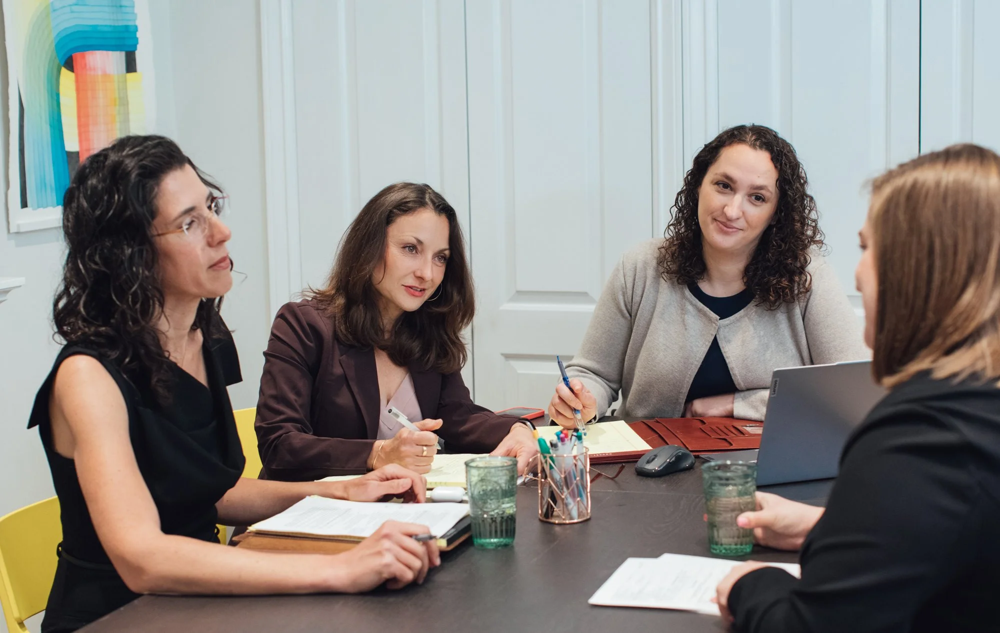 Five people in a meeting room