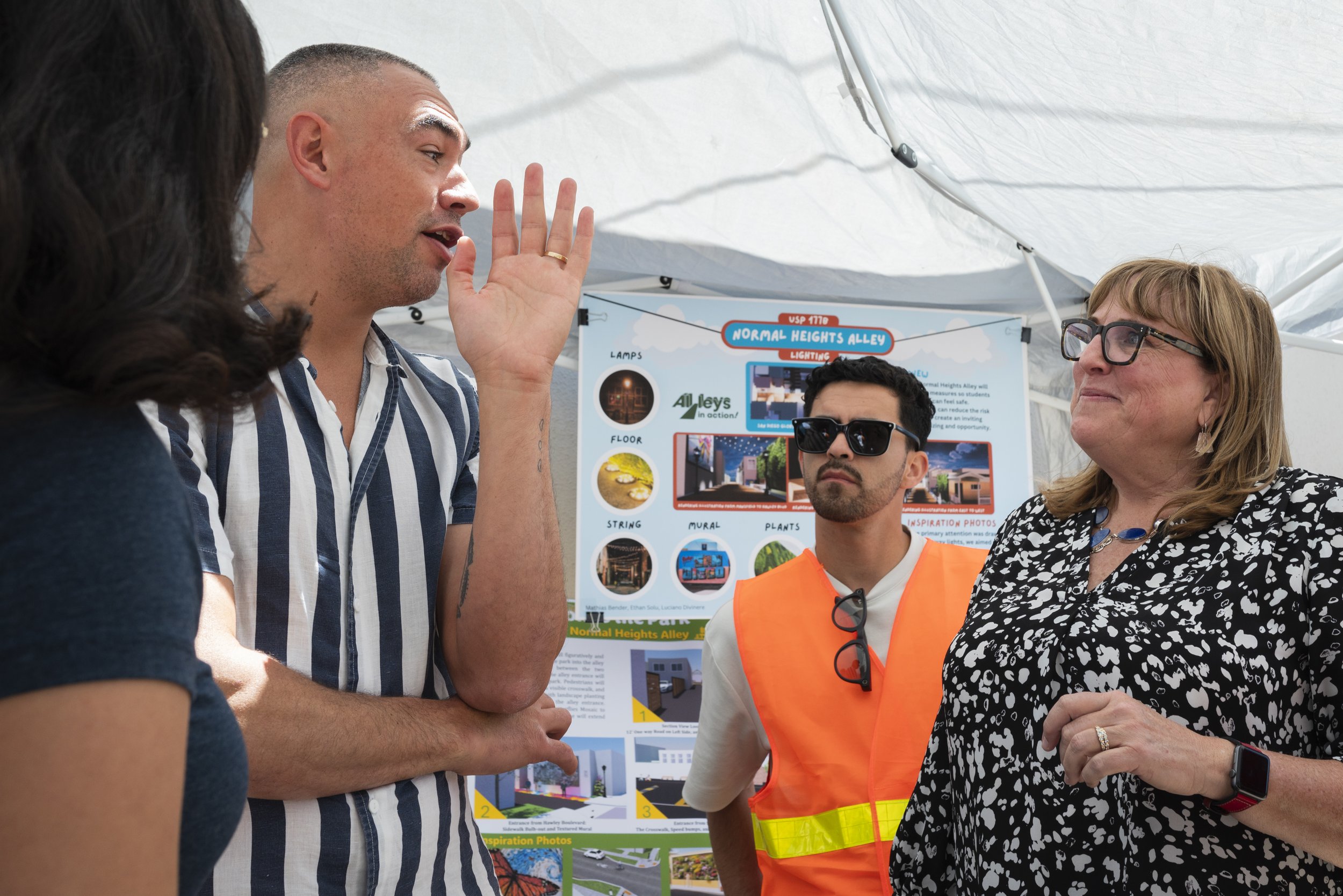San Diego City Council member Sean Elo-Rivera and UC San Diego Department of Urban Studies and Planning senior lecturer Sue Peerson converse as Peerson gives him a tour of an Alleys-In-Action community pop-up in Normal Heights on May 18, 2024.