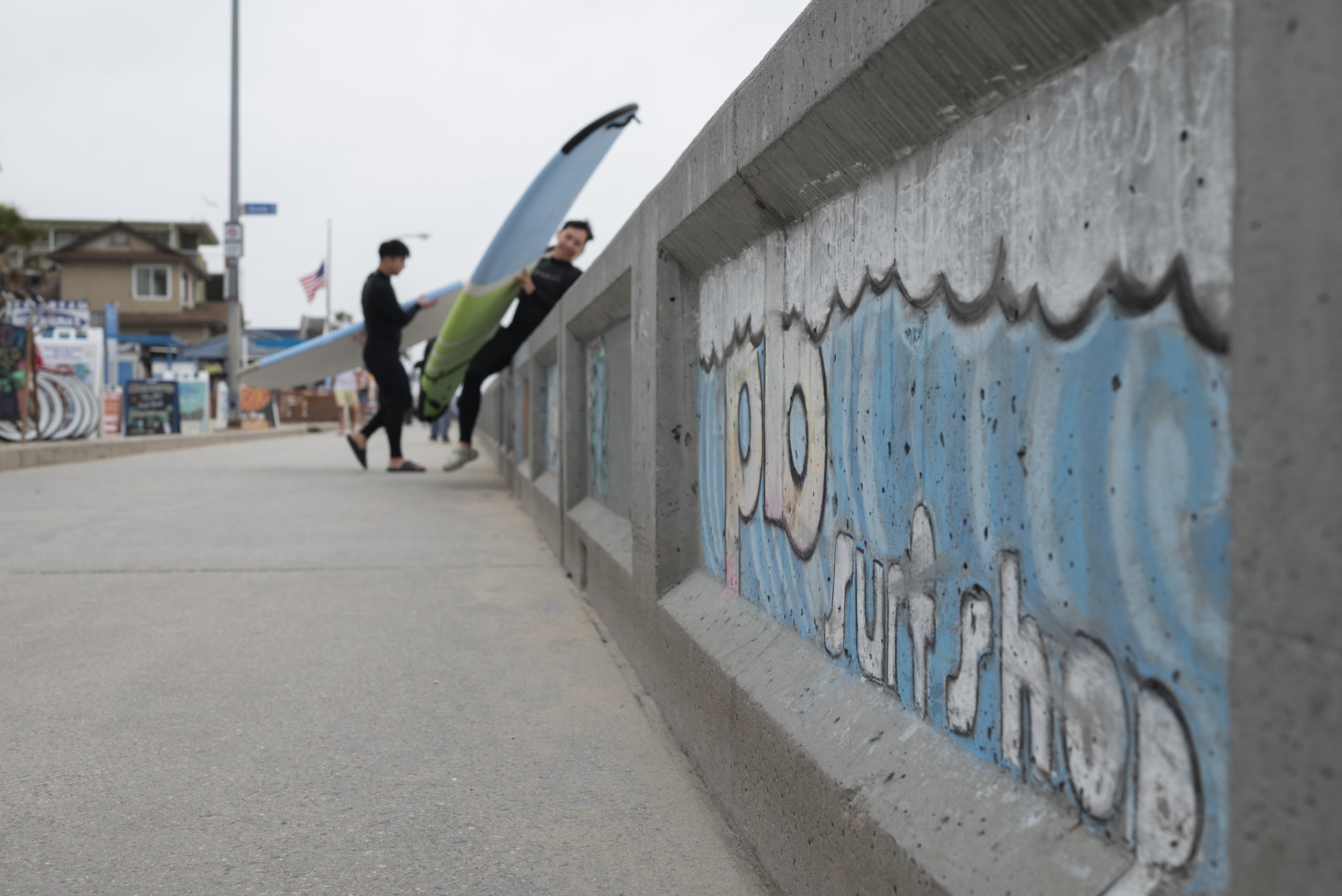 Surfers head towards the ocean after renting boards from Pacific Beach Surf Shop on May 2, 2026. (For The San Diego Union-Tribune)