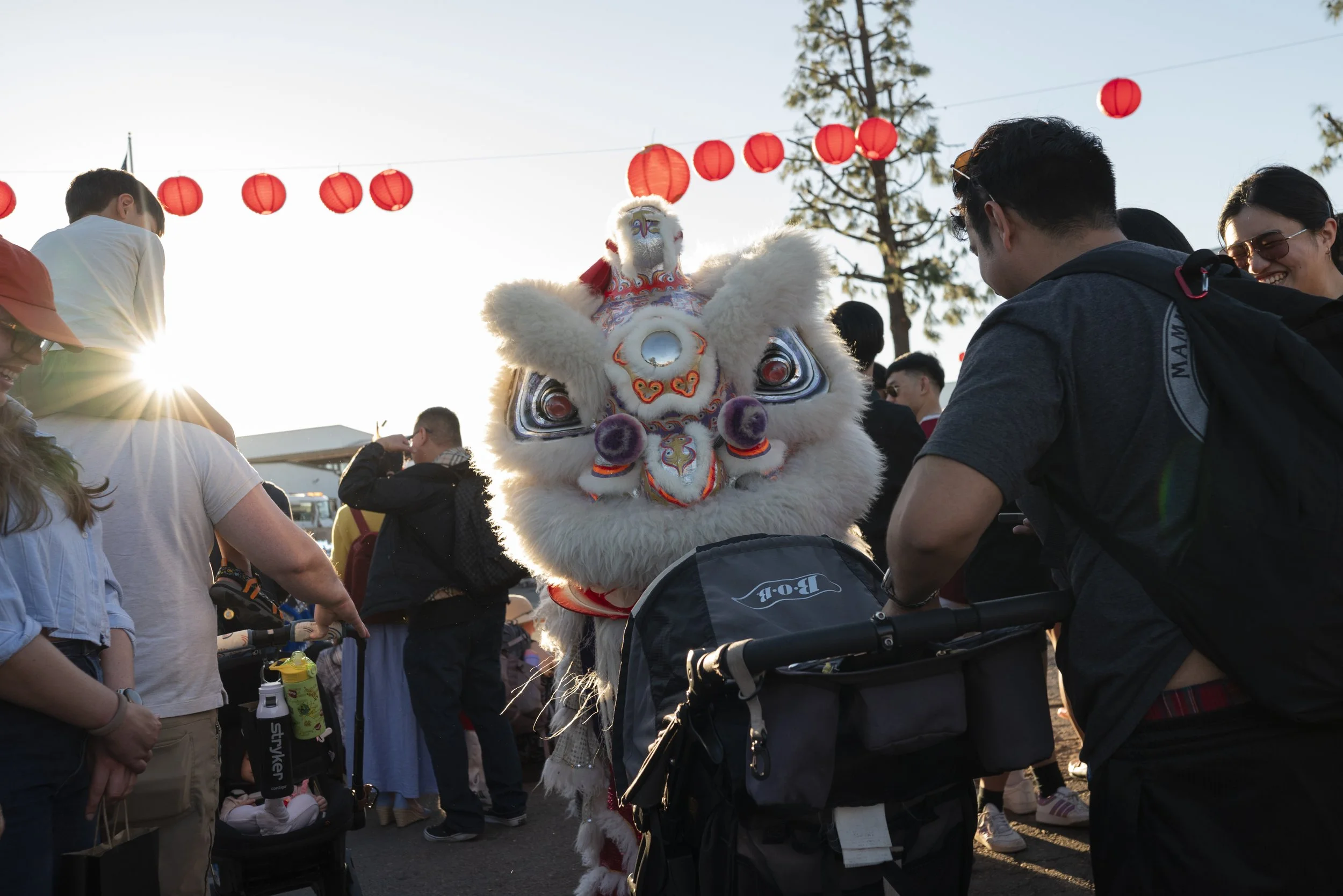 Lion dance performers interact with the crowd during  during the Lunar New Year kickoff celebration in the Convoy District on Sunday, February 8, 2026. (McKenzie Patterson / For The San Diego Union-Tribune)