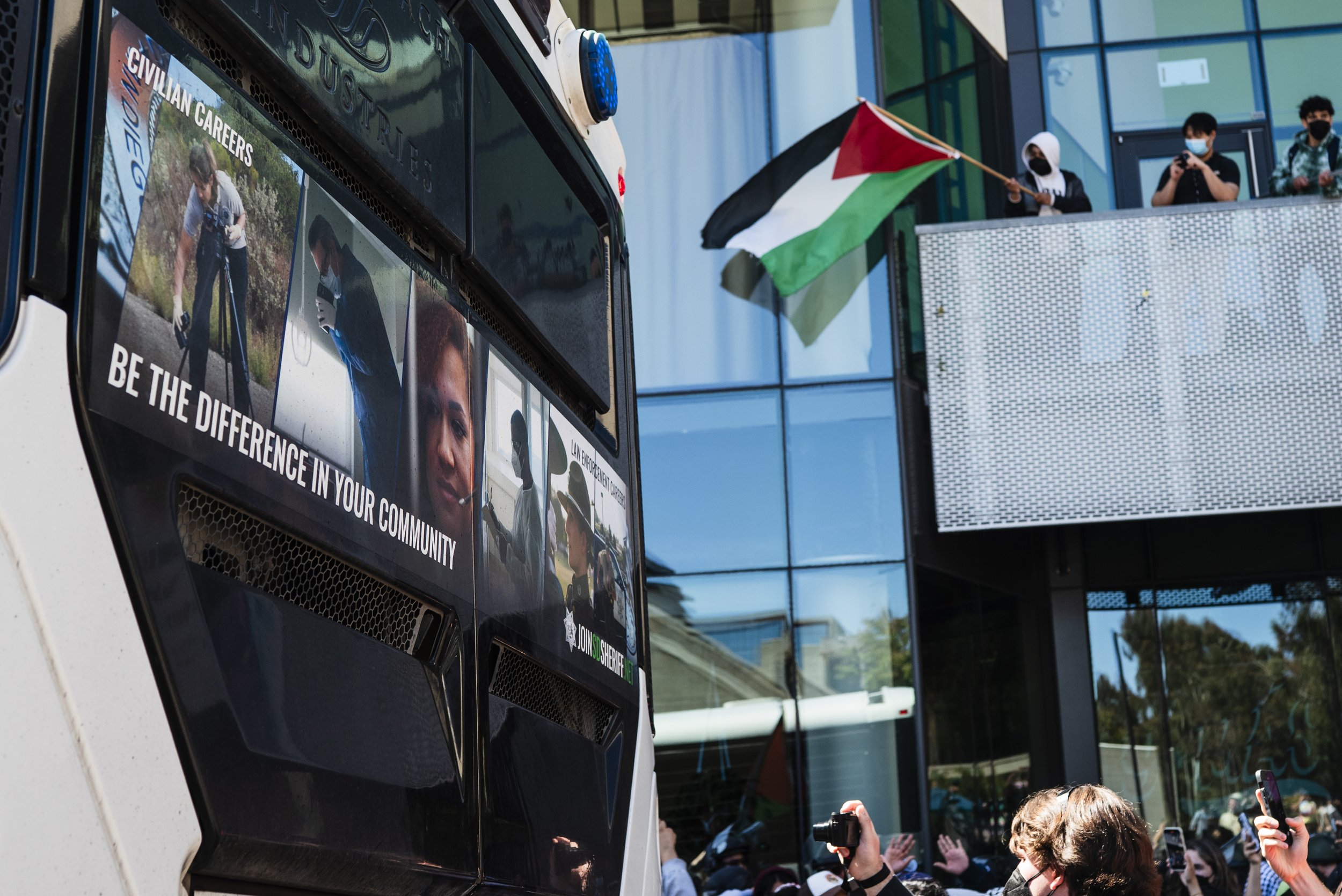 “Be the difference in your community” — printed on a police transport vehicle used to arrest 64 students and faculty at UC San Diego, May 6, 2024.