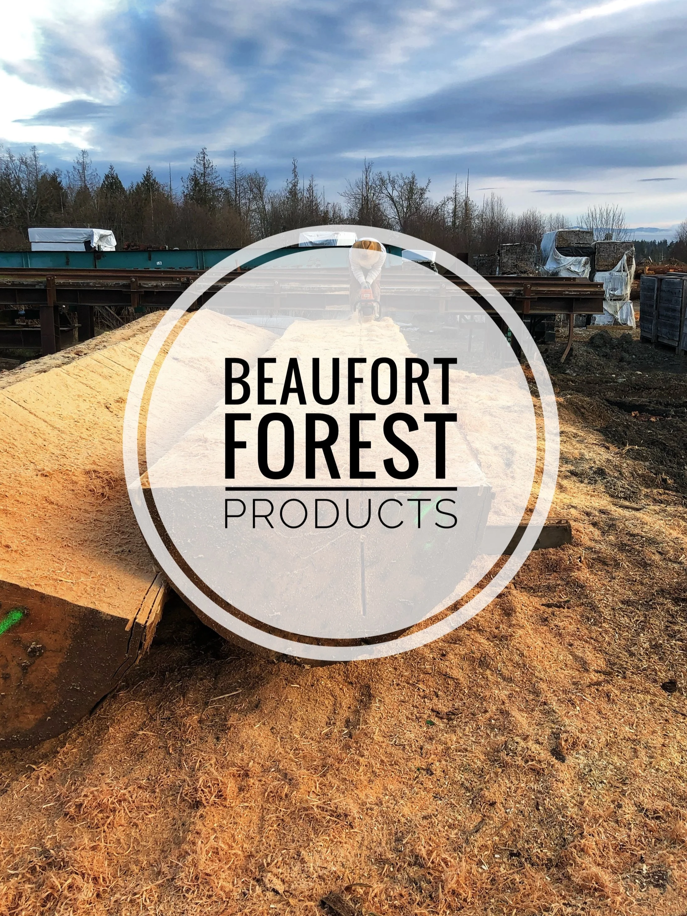A construction worker is operating a power saw on a piece of wood at an outdoor construction site with trees and cloudy sky in the background, with a logo reading "Beaufort Forest Products" overlayed.