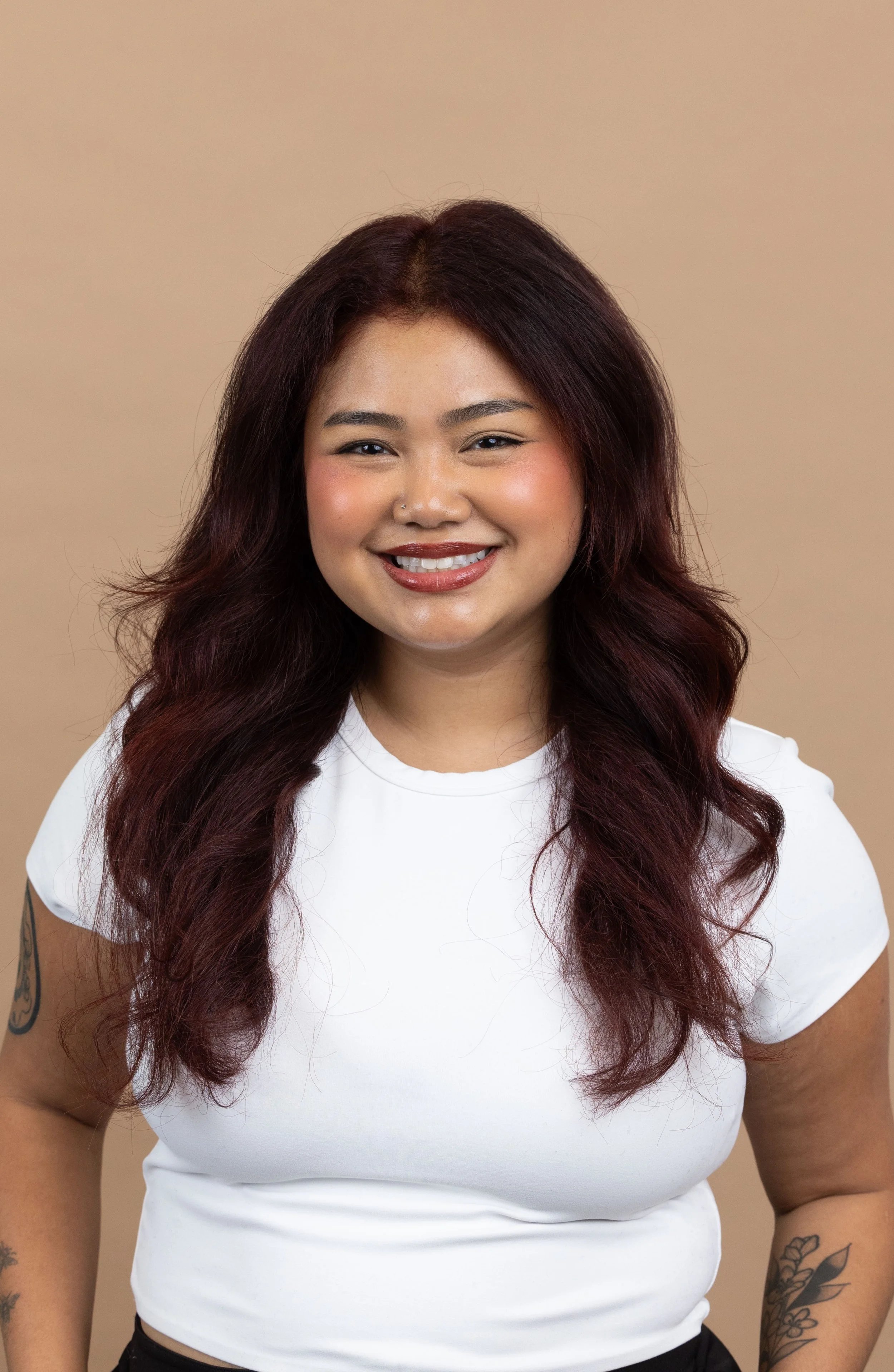 Brittany Yann Headshot against Tan Background