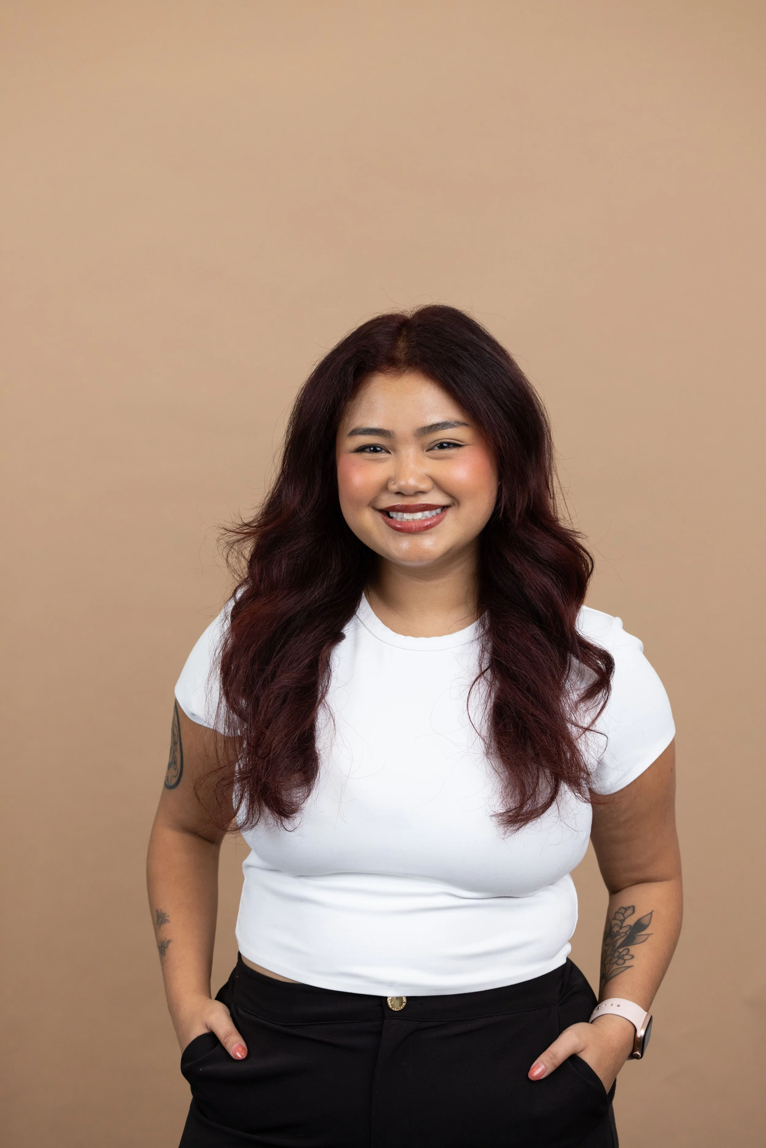 Brittany Yann Headshot against Tan Background