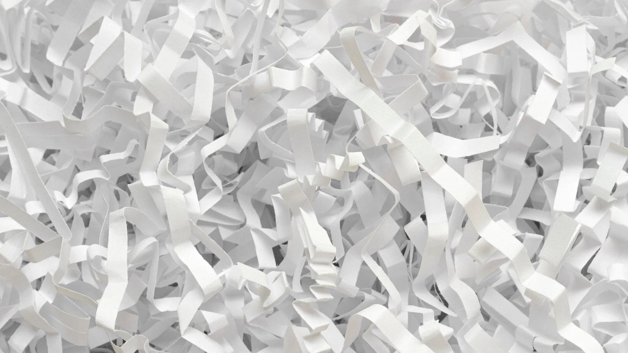 Shredded paper flat lay illustrating secure document shredding services