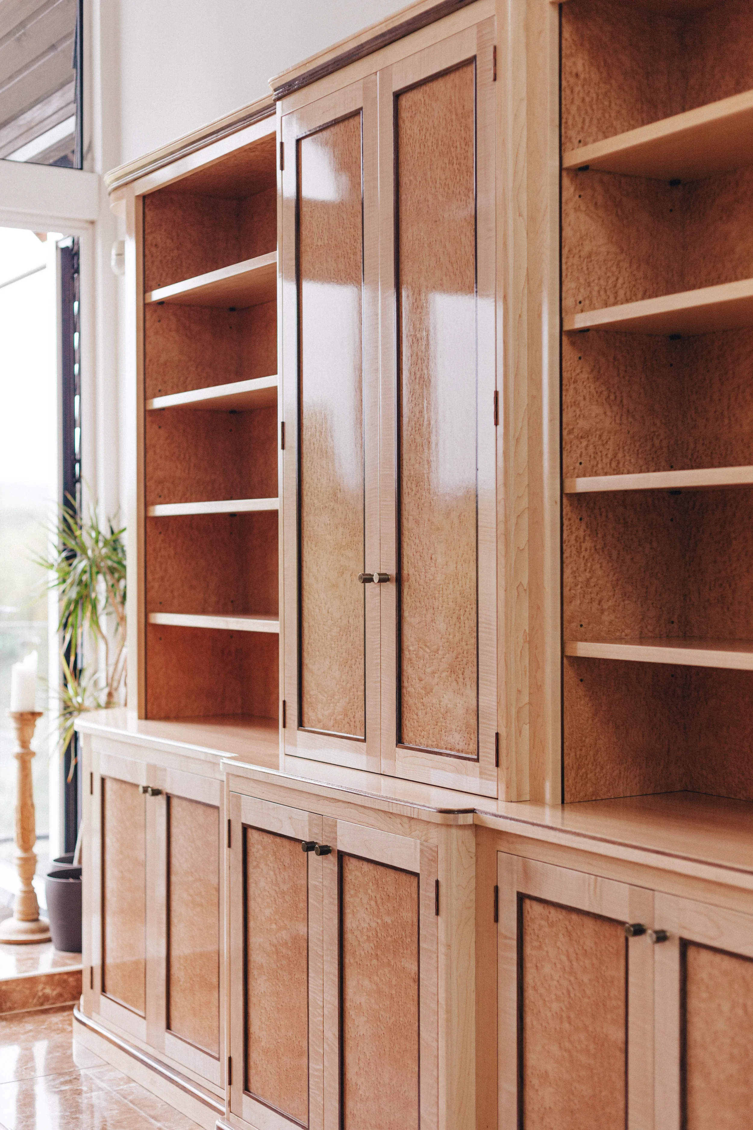 A prepared veneer Birdseye Maple and American Black Walnut shelving unit in a high gloss finish with dramatic figuring and curved shelving