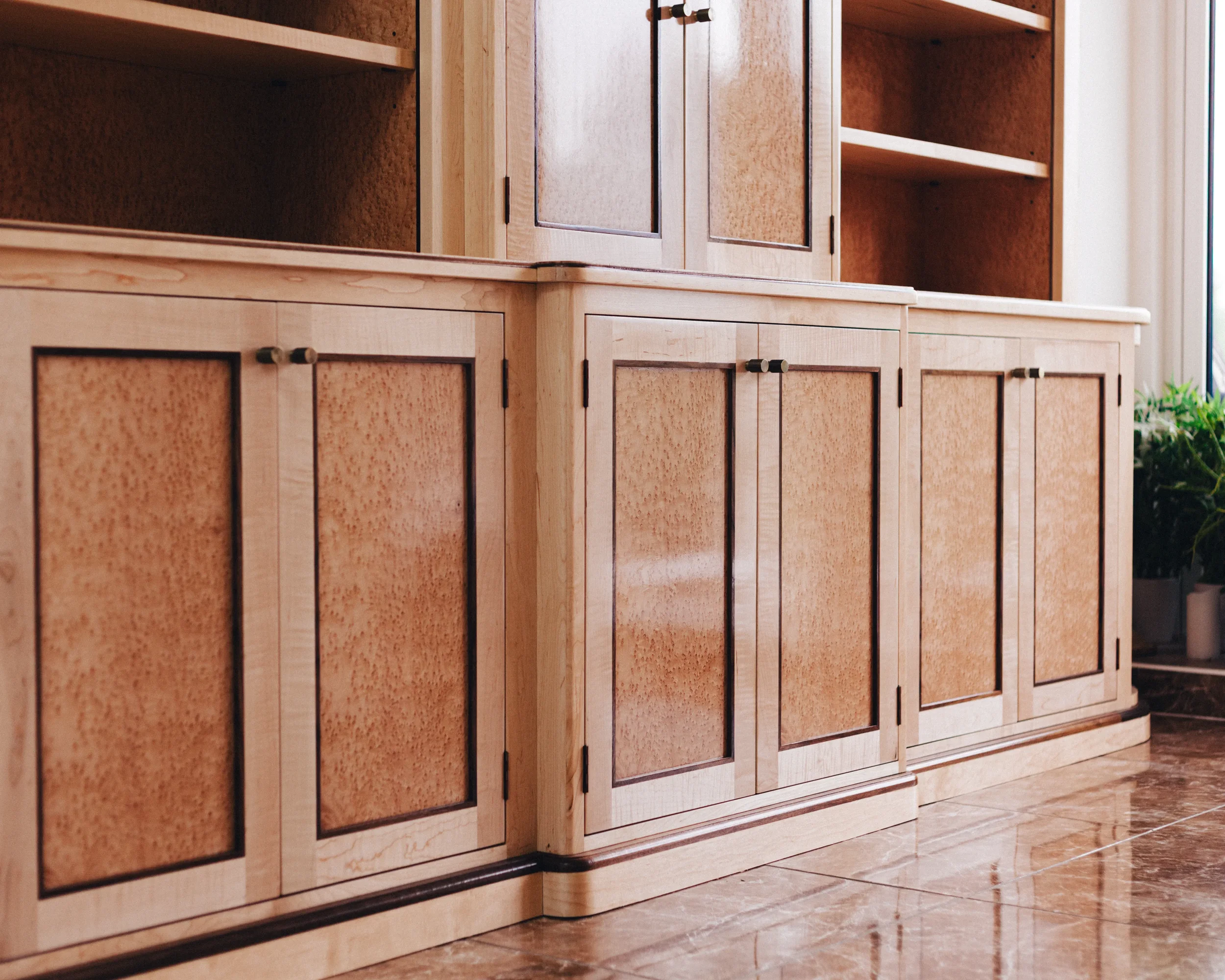 A prepared veneer Birdseye Maple and American Black Walnut shelving unit in a high gloss finish with dramatic figuring and curved shelving
