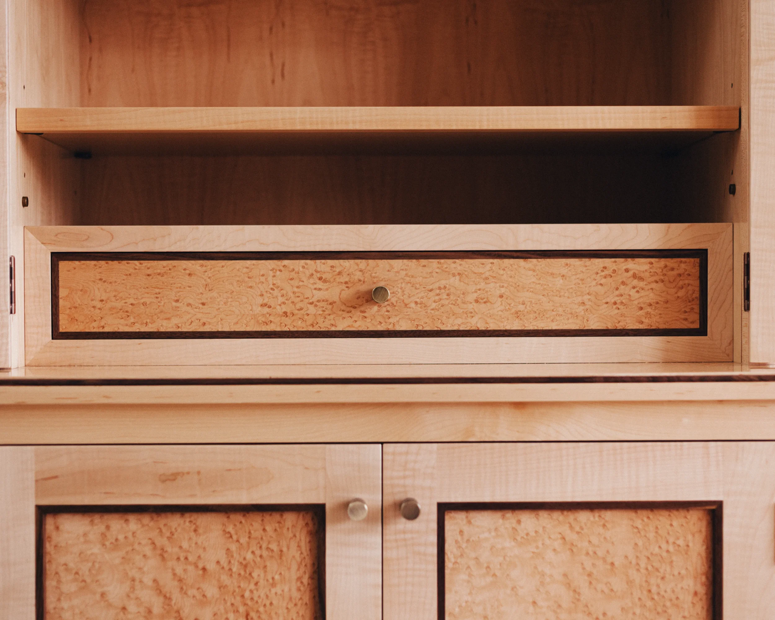 A prepared veneer Birdseye Maple and American Black Walnut shelving unit in a high gloss finish with dramatic figuring