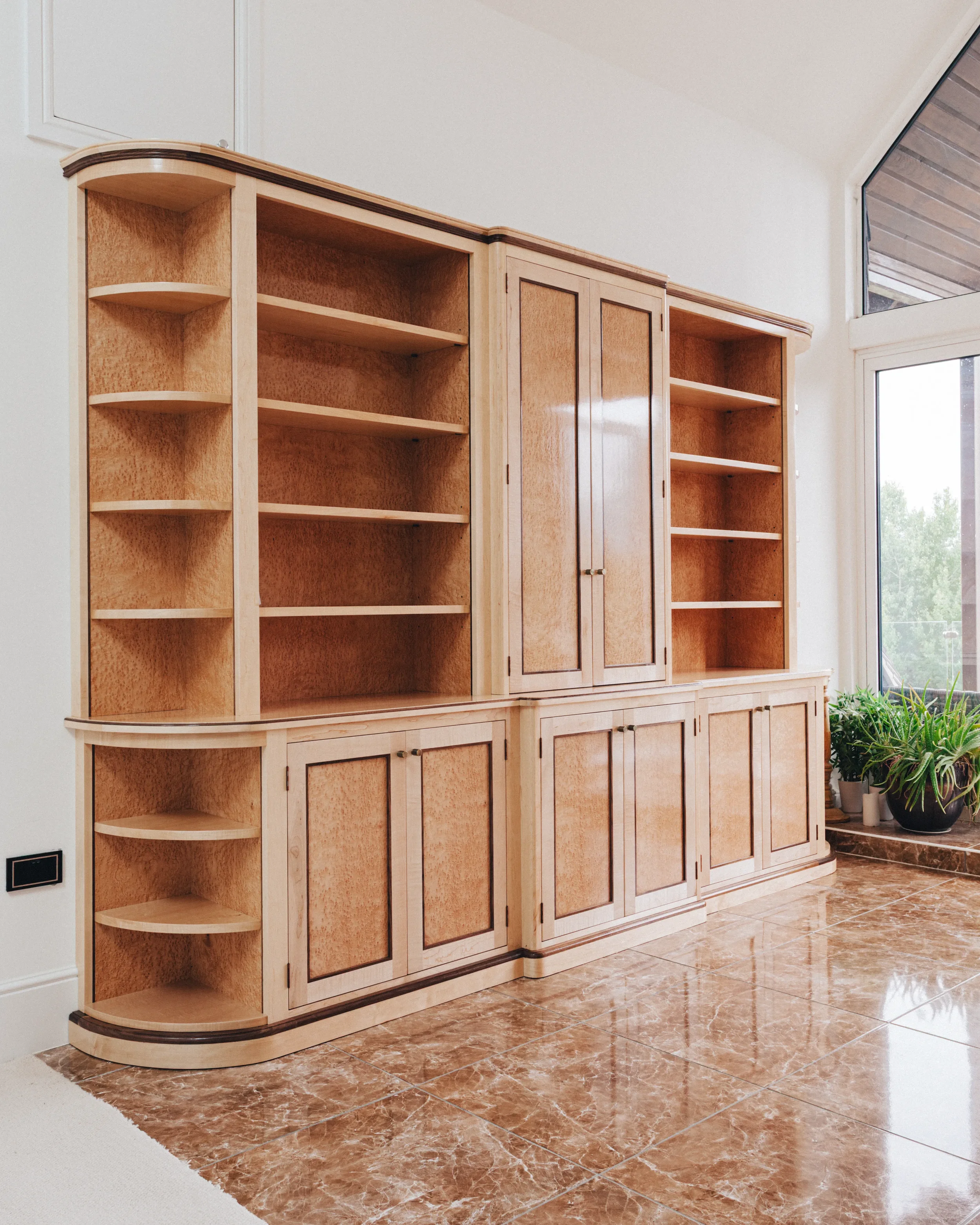 A prepared veneer Birdseye Maple and American Black Walnut shelving unit in a high gloss finish with dramatic figuring and curved shelving