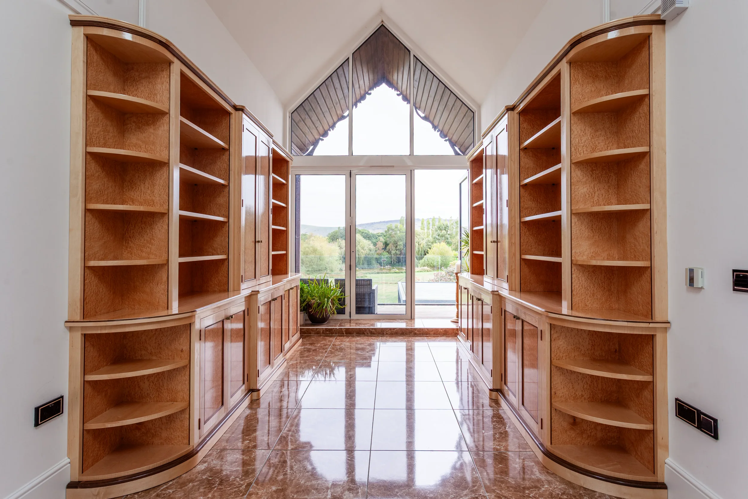 A pair of prepared veneer Birdseye Maple and American Black Walnut shelving units in a high gloss finish with dramatic figuring and curved shelving