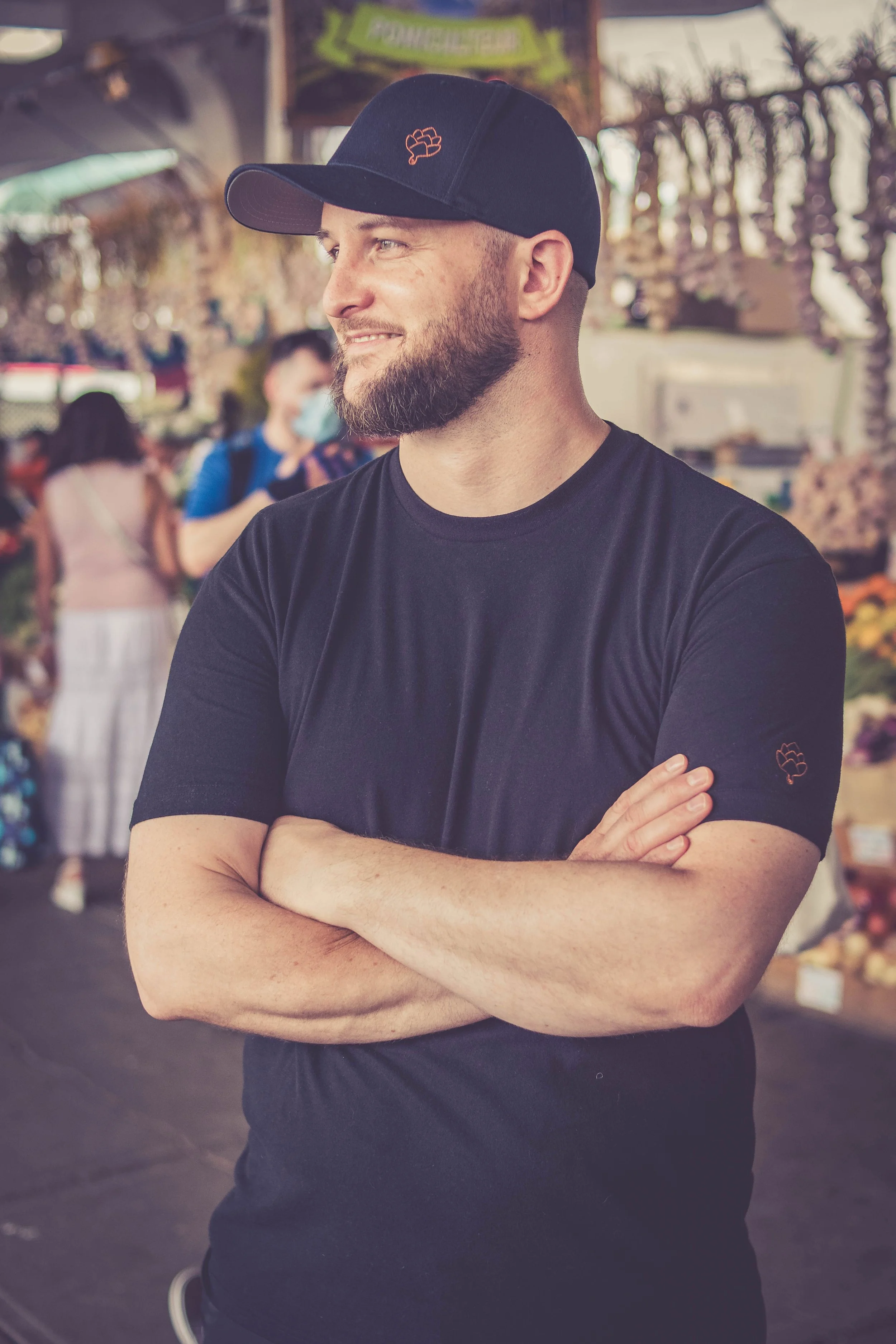 A portrait of Chef Collin Strohbach at a public market.