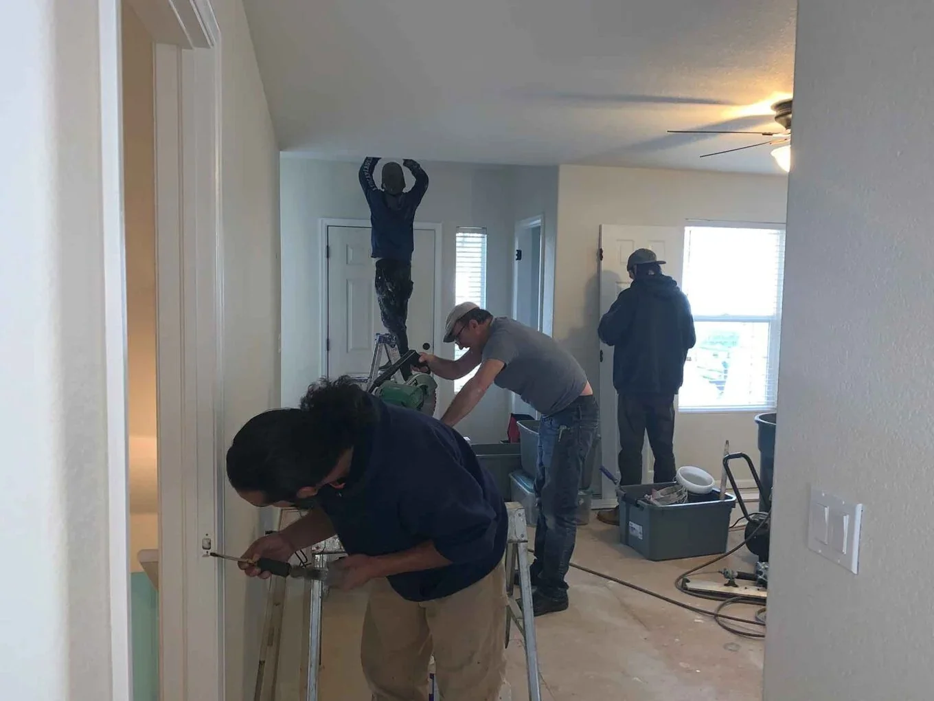 Home Help Remodeling crew performing active interior home renovation, door hardware installation, and carpentry work in Baltimore.