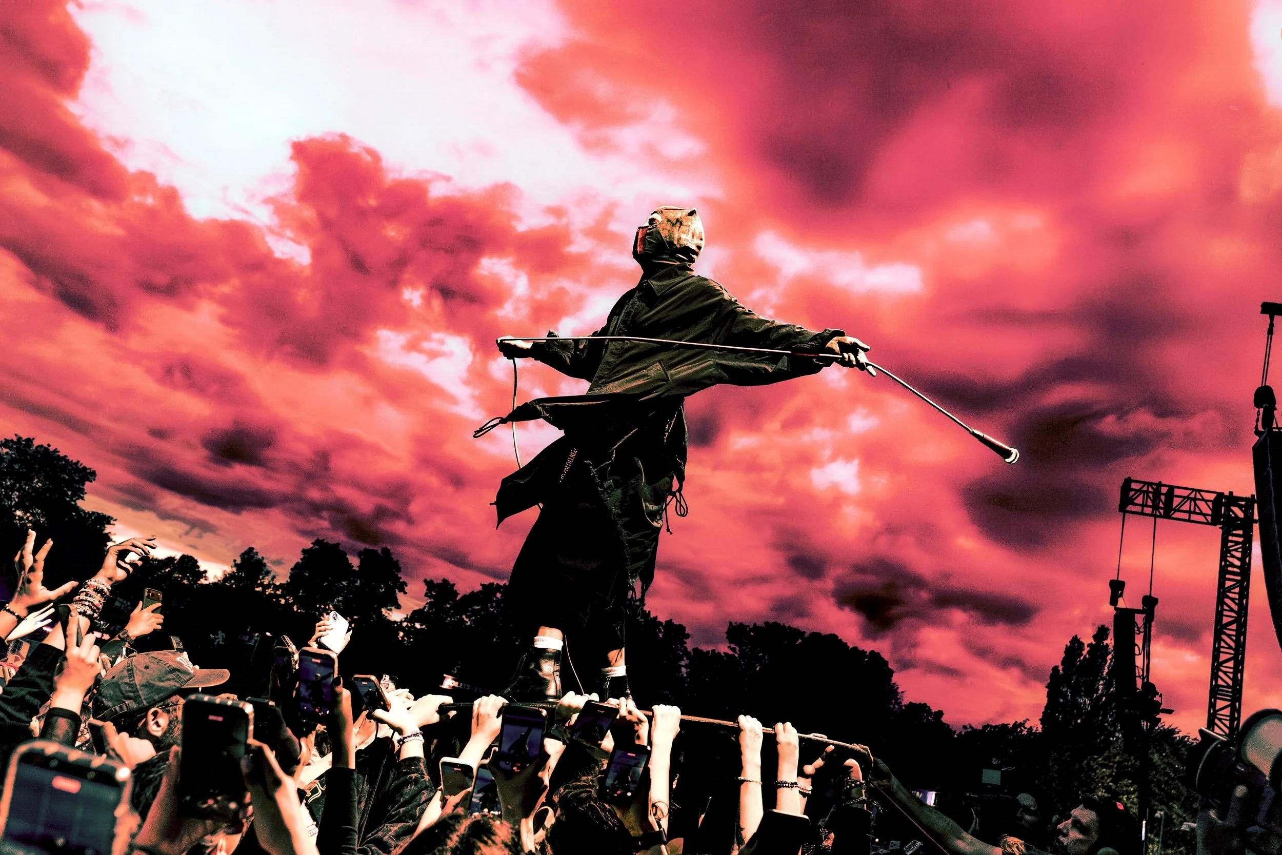TYLER JOSEPH from TWENTY ONE PILOTS stands on crowd against a deep pink sky at All Points East Festival 2026 in Victoria Park, London. 