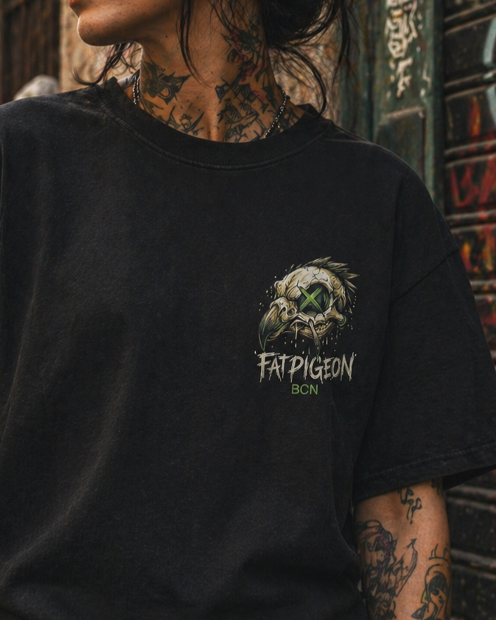 Black oversized graphic t-shirt with left chest pigeon skull logo, neon green eye detail, Fat Pigeon BCN branding, Barcelona streetwear fashion, premium urban skater tee for men and women.