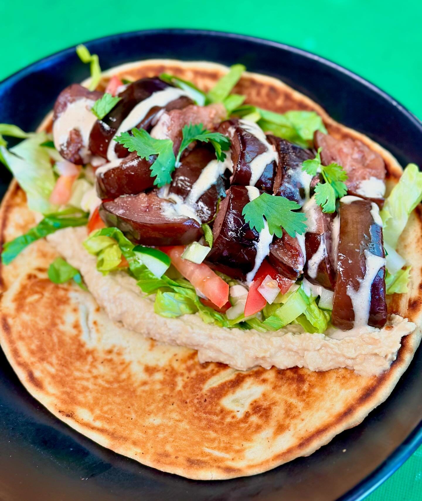 You don&rsquo;t have to be vegan to enjoy this SPECIAL.

This Ultimate Veggie Wrap is jam packed and filling. 

Roasted eggplant, hummus, romaine, tomato, onion, and cucumber. Drizzled with tahini sauce. Want it spicy? Just ask! We got you. $14.95
.
