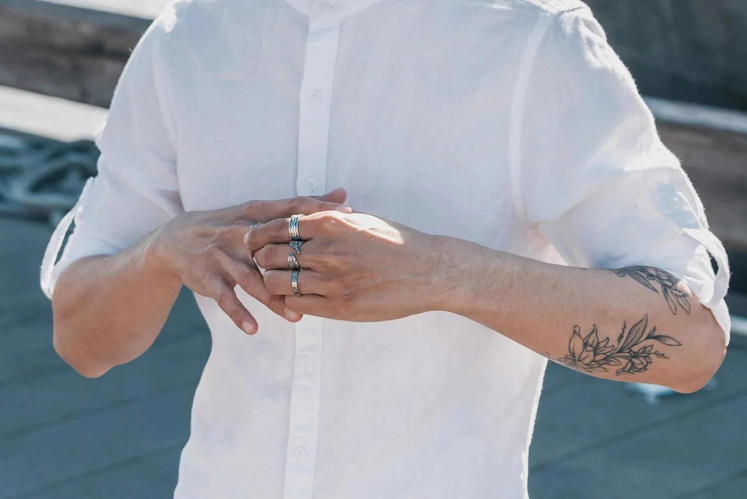 Man wearing multiple rings on fingers unsure about how to secretly get ring size