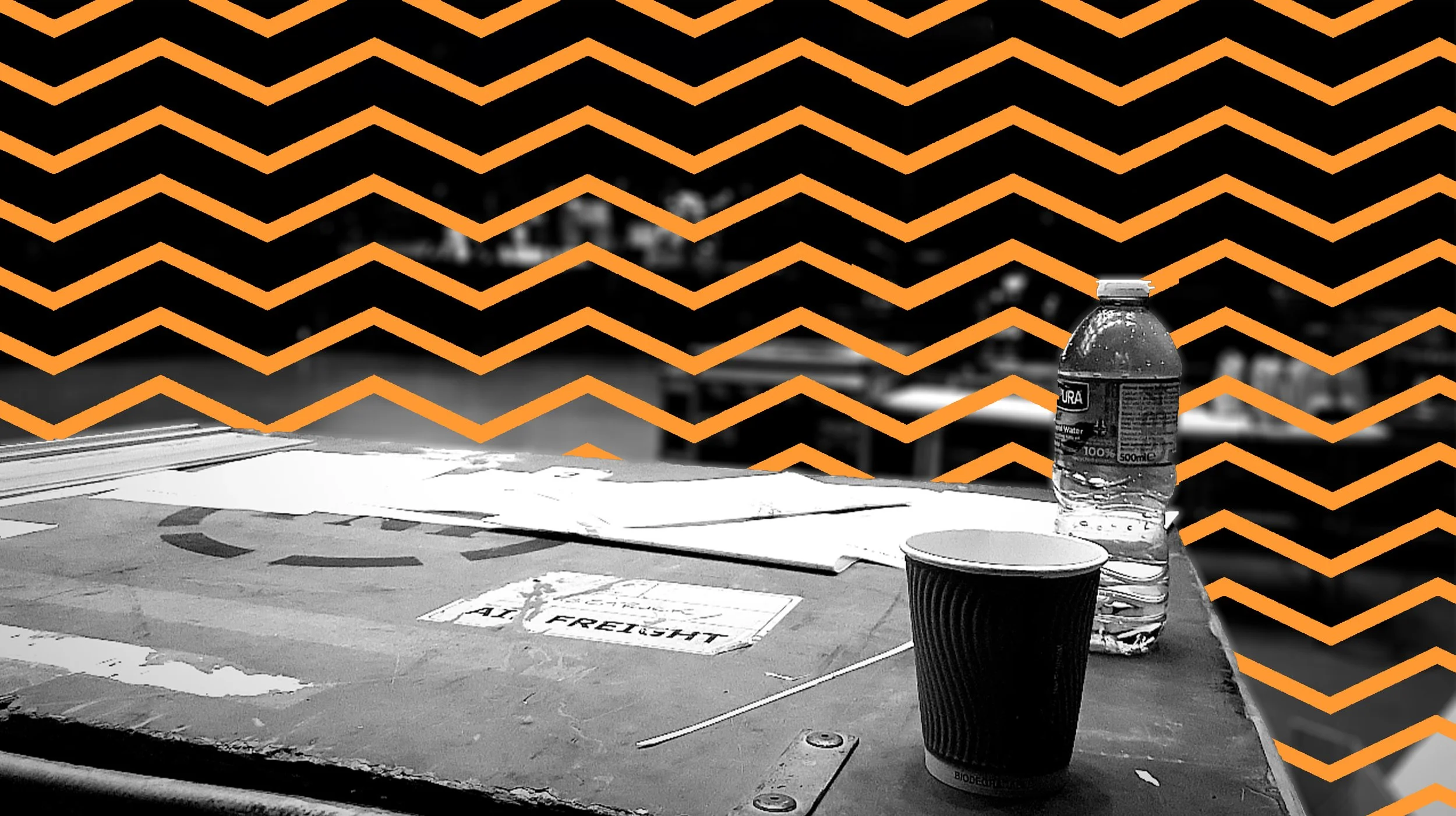 A photo of a case with a coffee cup on top, featuring orange zigzag lines across the image, adding a modern touch and emphasizing the blend of practicality and style in event production.