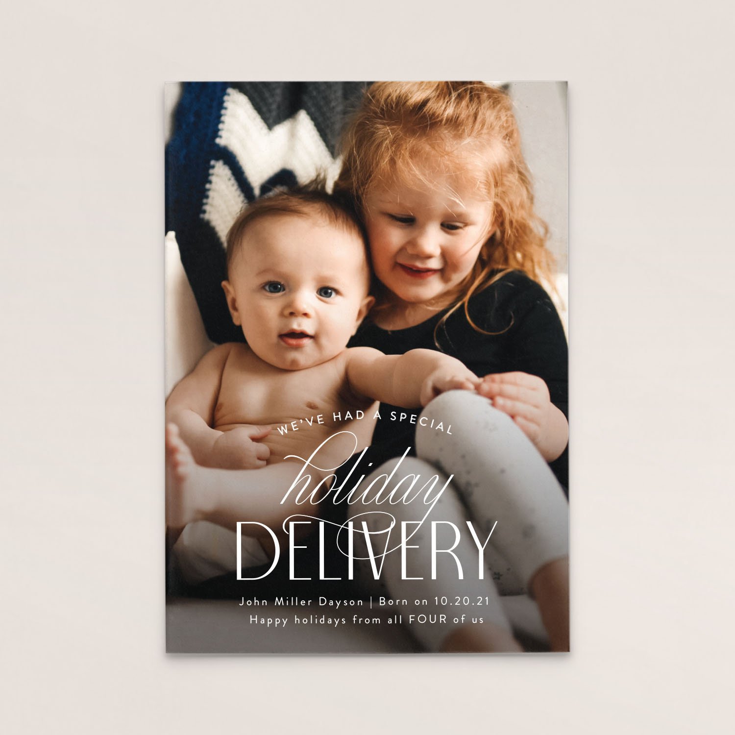 A holiday greeting card with a photo of a red-haired girl and a baby boy, with text that reads "We've had a special holiday" and details about the baby including his name, birth date, and holiday wishes.
