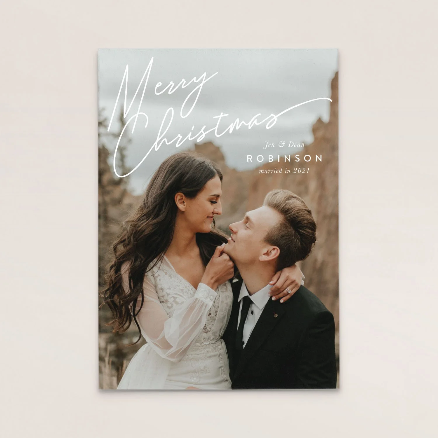A wedding photo of a couple in formal attire outdoors, with text that says 'Merry Christmas Jen & Dean Robinson married in 2021'