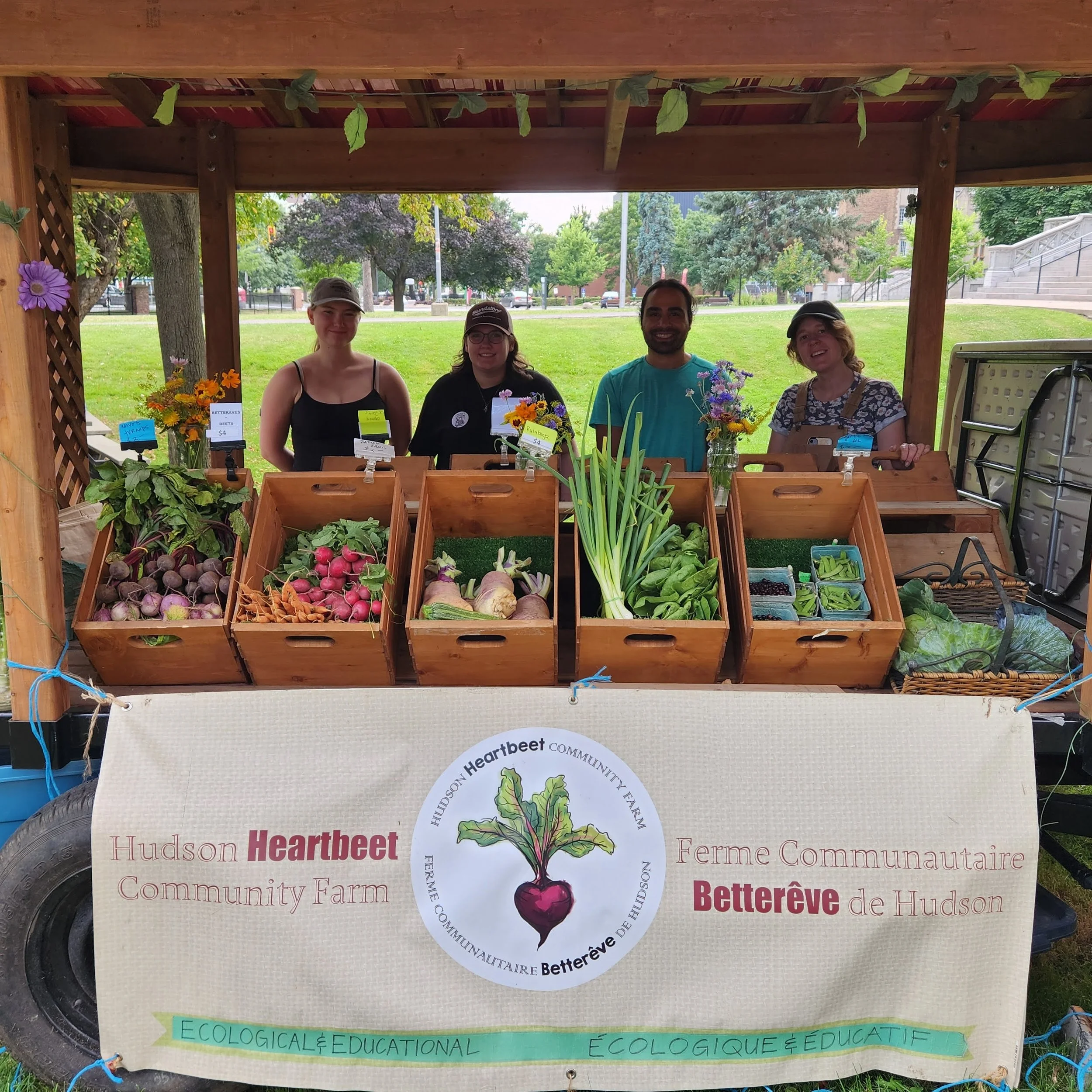 Group of people selling produce at the Concordia Farmers Market