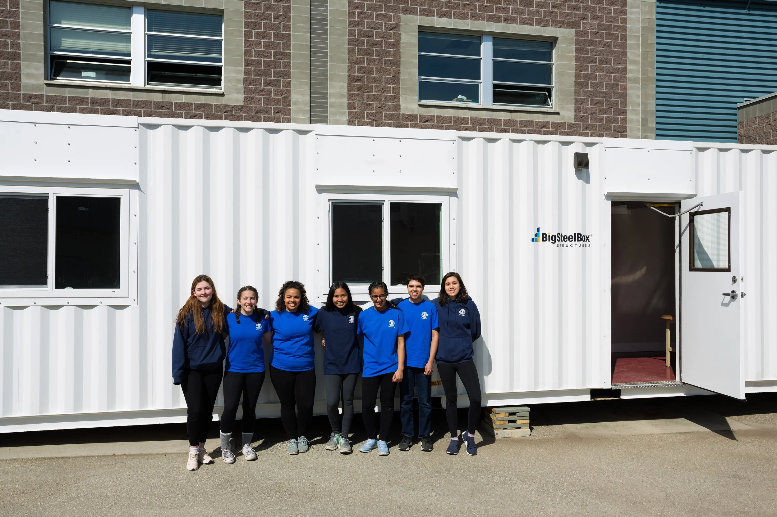 Seven students outside of the Operation Take Two workspace in Kelowna, BC.