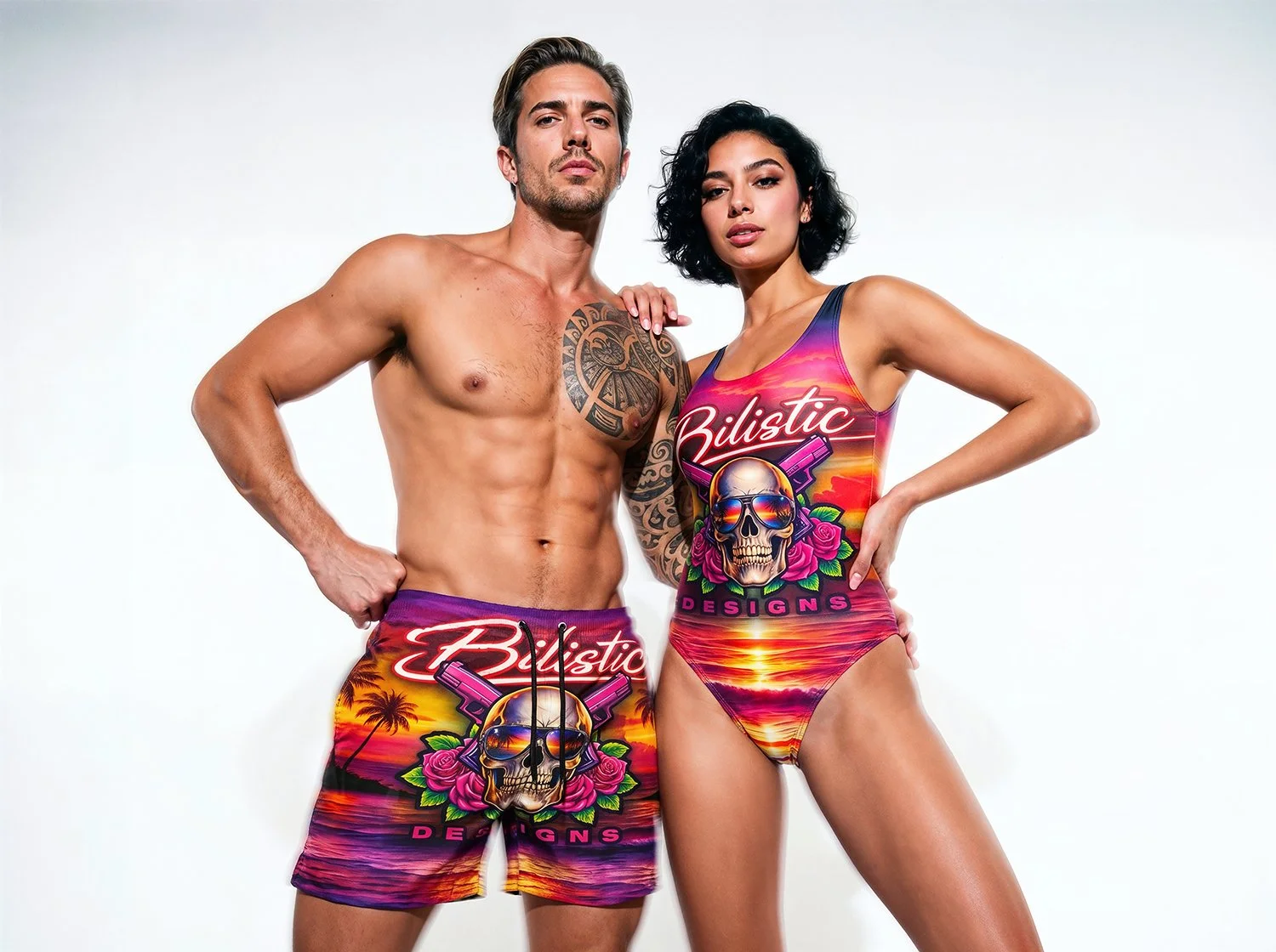 A shirtless man and a woman in a colorful swimsuit with skull and sunset design stand arm in arm against a white background.