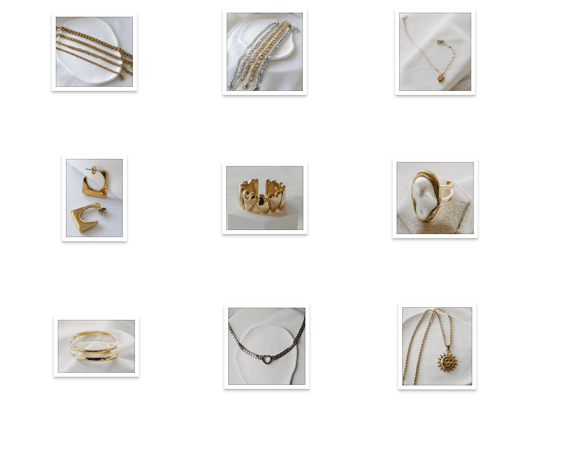 Collection of various gold and silver jewelry items including necklaces, bracelets, rings, and earrings displayed on white surfaces.