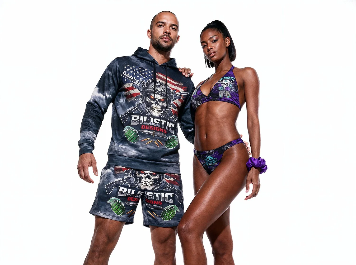 A man and woman stand together against a white background, both dressed in tank tops and shorts with military-style and skull-themed designs. The man is wearing a hoodie and shorts with a skull and American flag motif, and the woman is wearing a purple bikini with similar graphics.