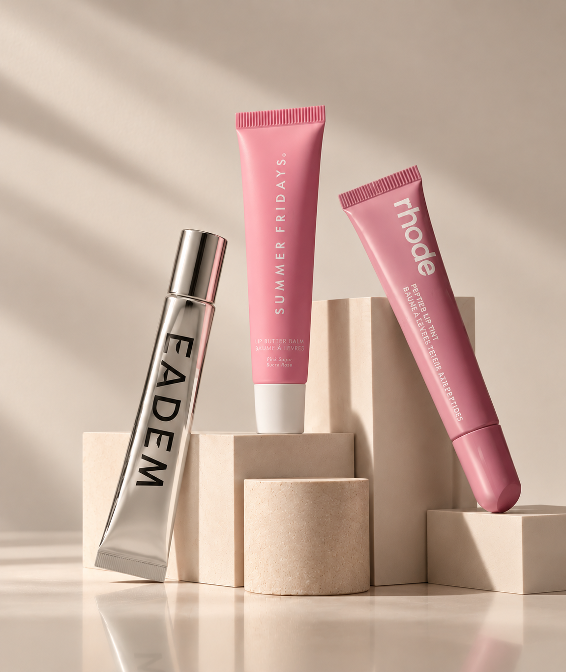 Luxury Lip Balm Trio on Beige Pedestals.png