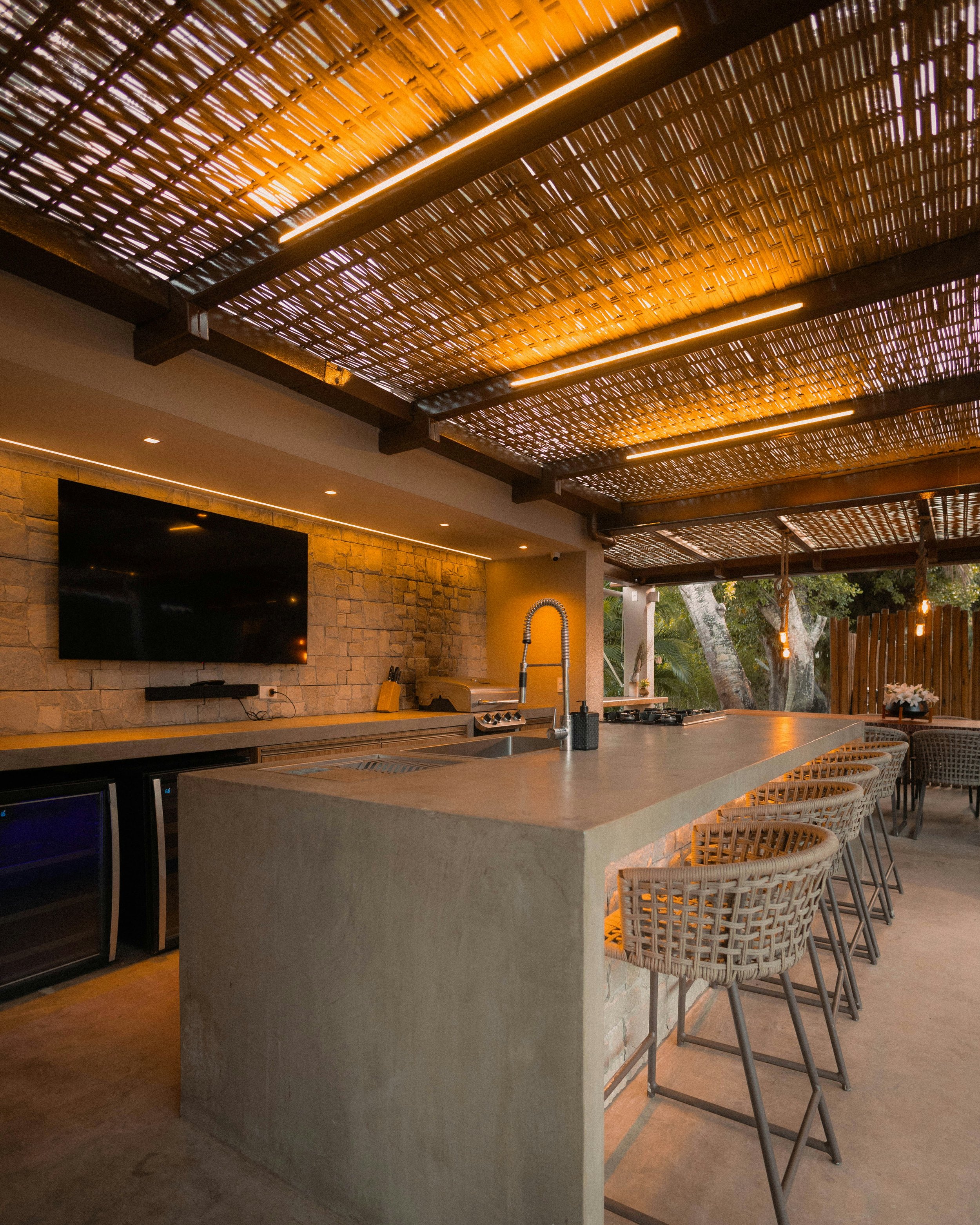 Outdoor living space with integrated kitchen and lighting