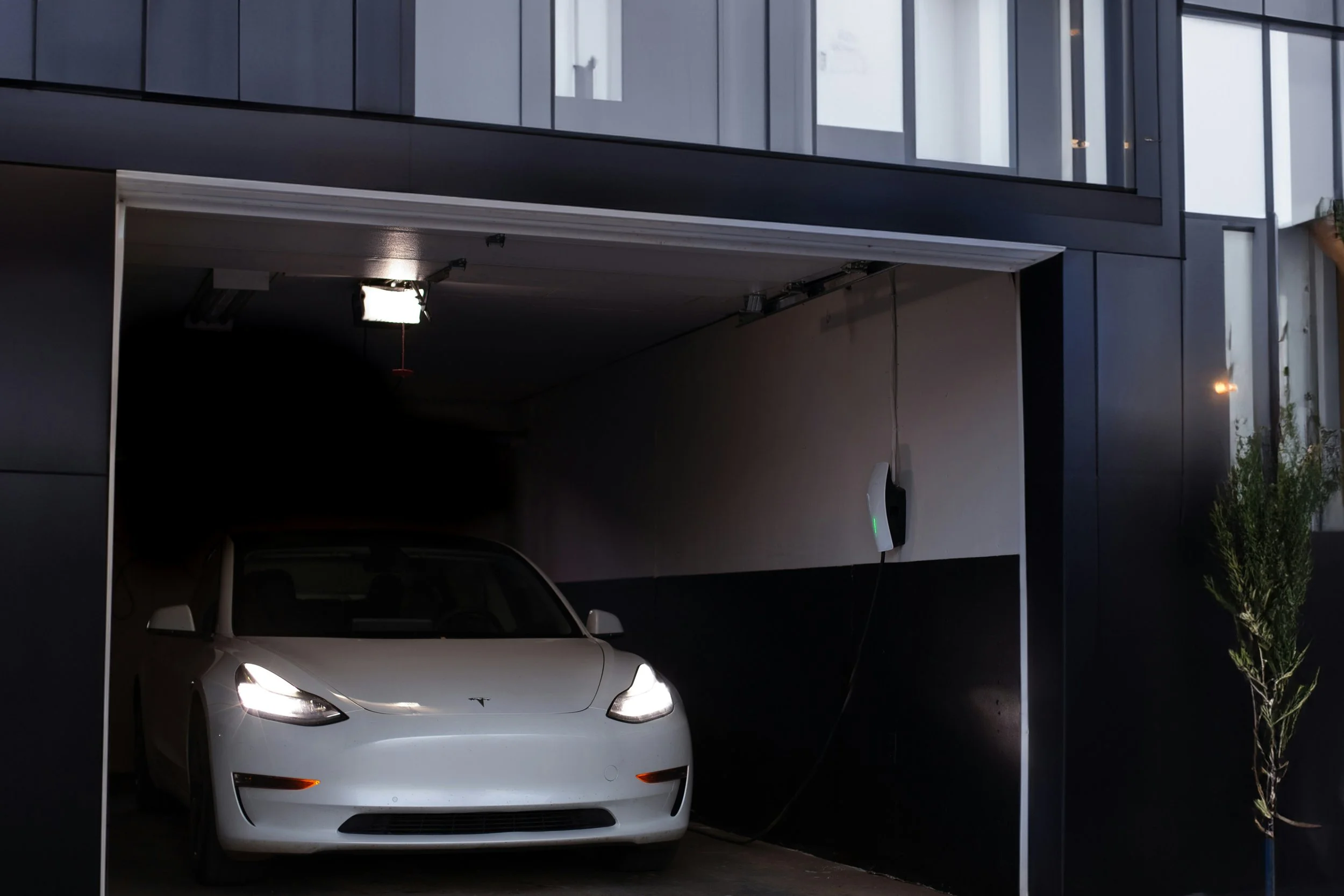 Electric vehicle charging station in a home garage