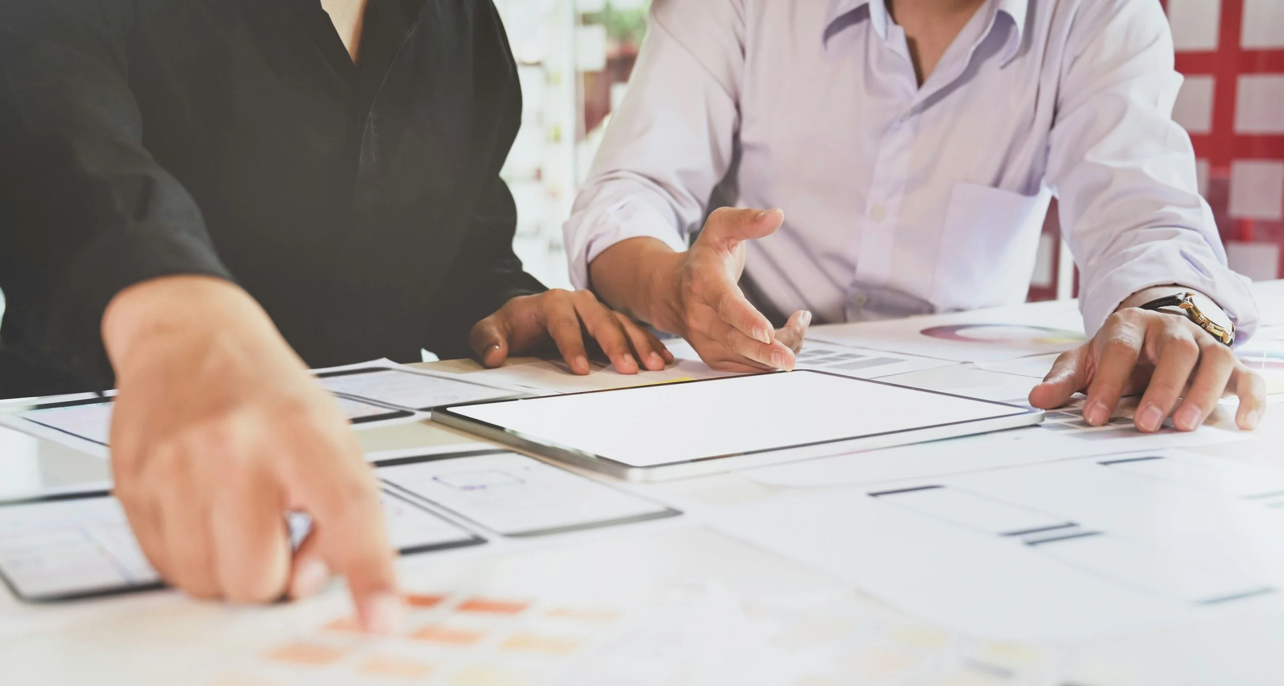 Two people sit at a desk strategically planning their organization's succes