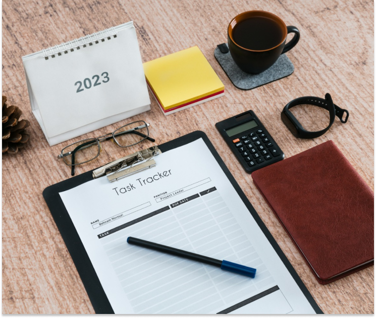 Many office supplies are organized neat and tidy on a desk.