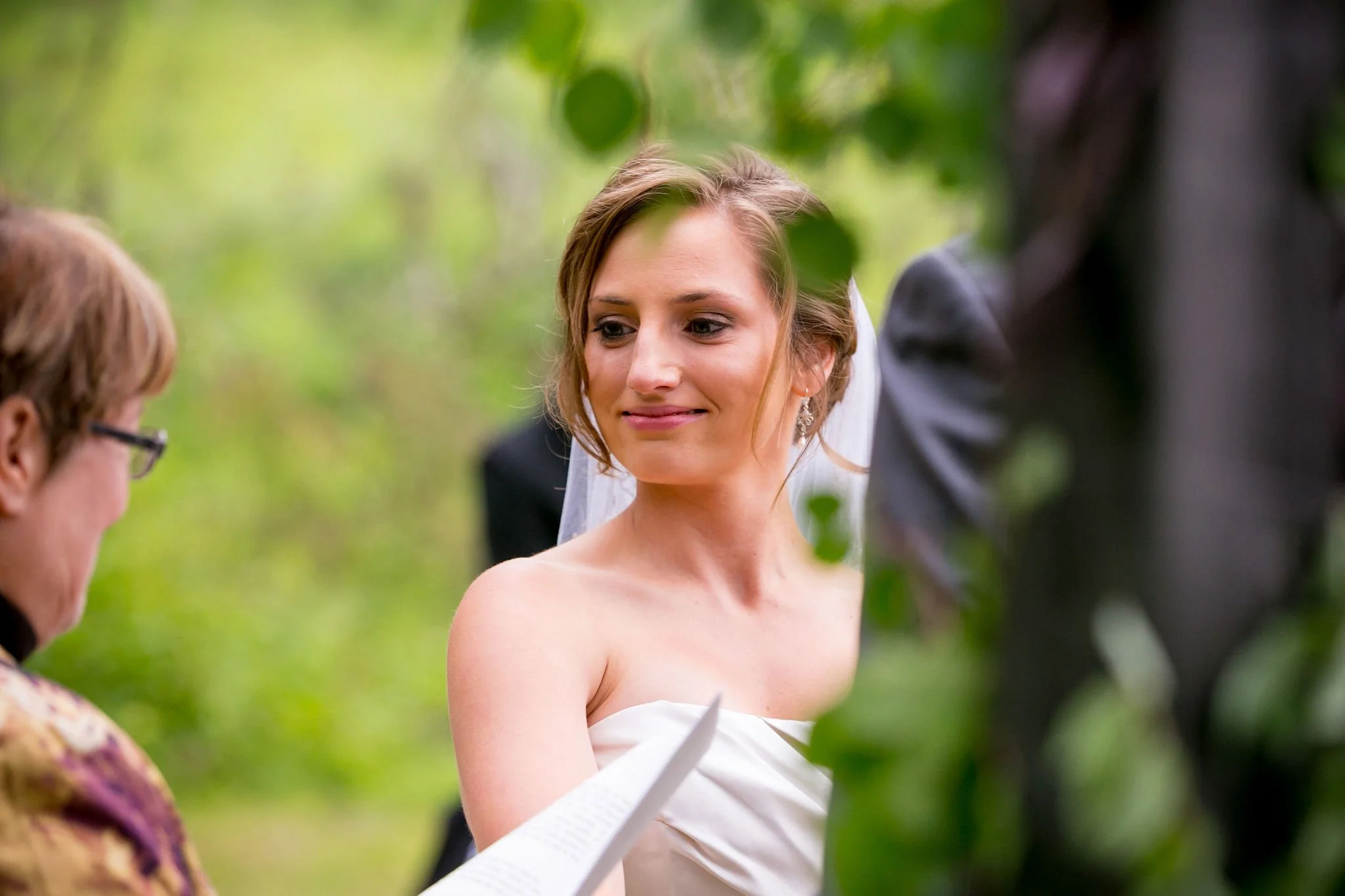 Bride with bouquet during outdoor wedding ceremony