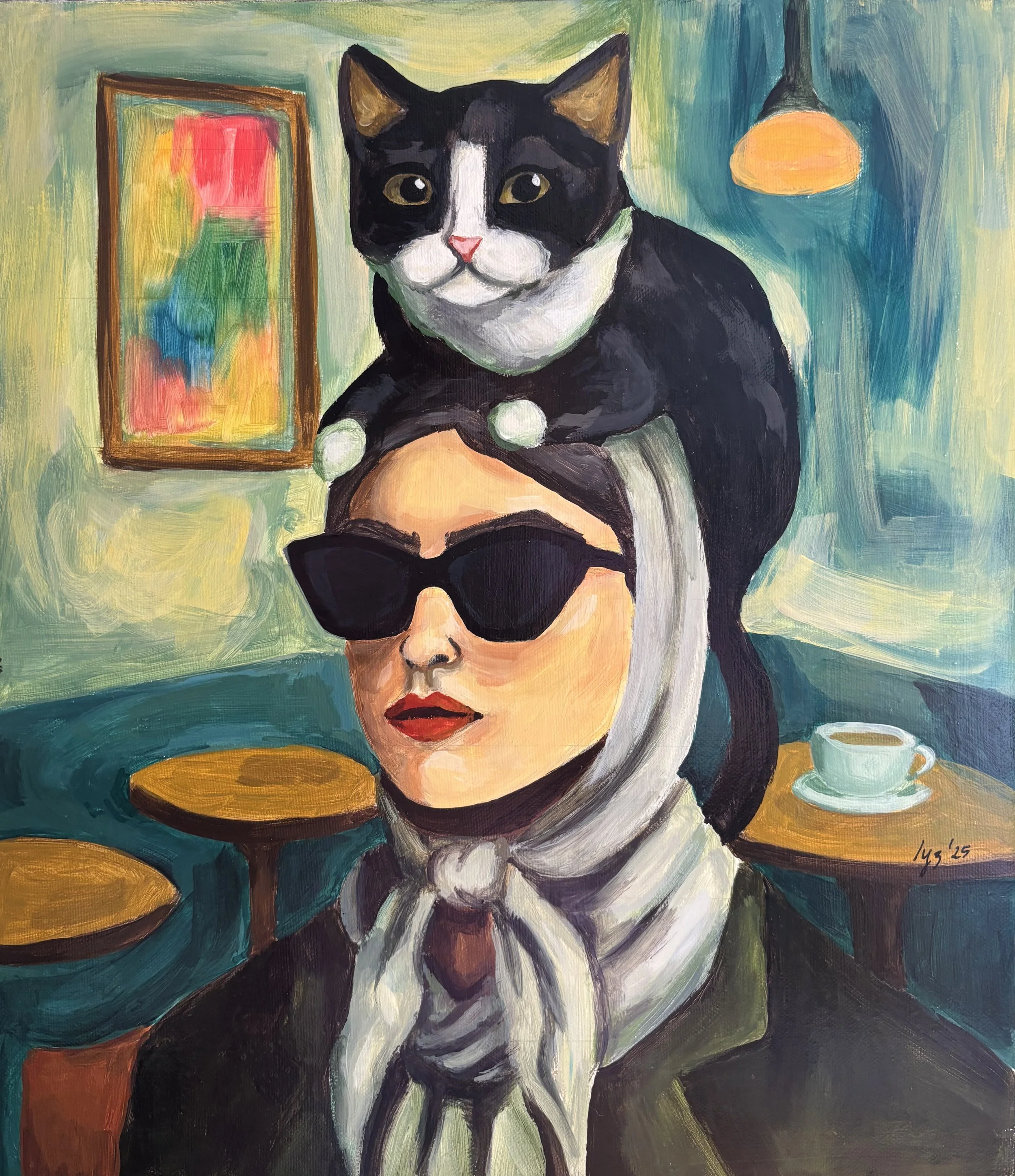 A woman wearing black sunglasses, red lipstick, and a beige headscarf with a bow, sits at a table with a cup of coffee. A black and white cat is perched on her head. The background features a colorful painting, a hanging lamp, and a teal-colored wall