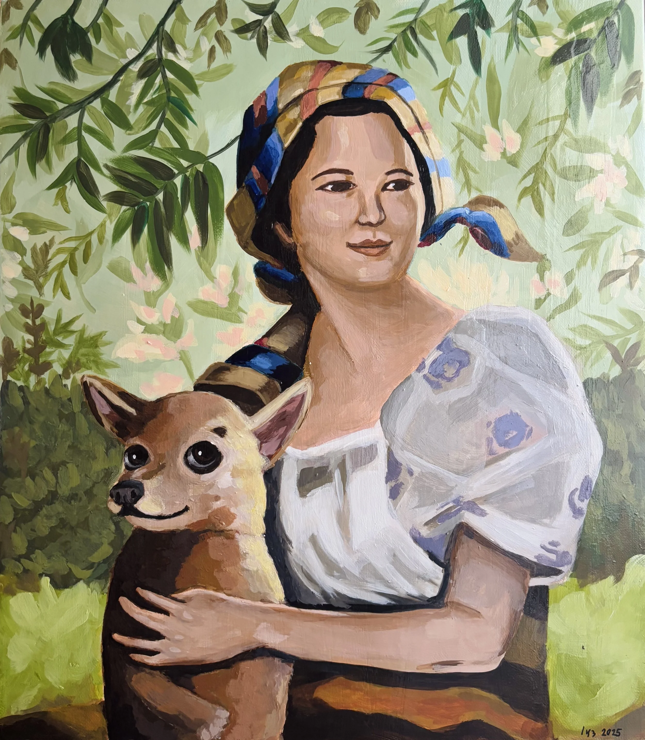 A woman with dark hair, wearing a colorful headscarf, holding a small dog with large eyes. The background features green foliage and pink flowers.
