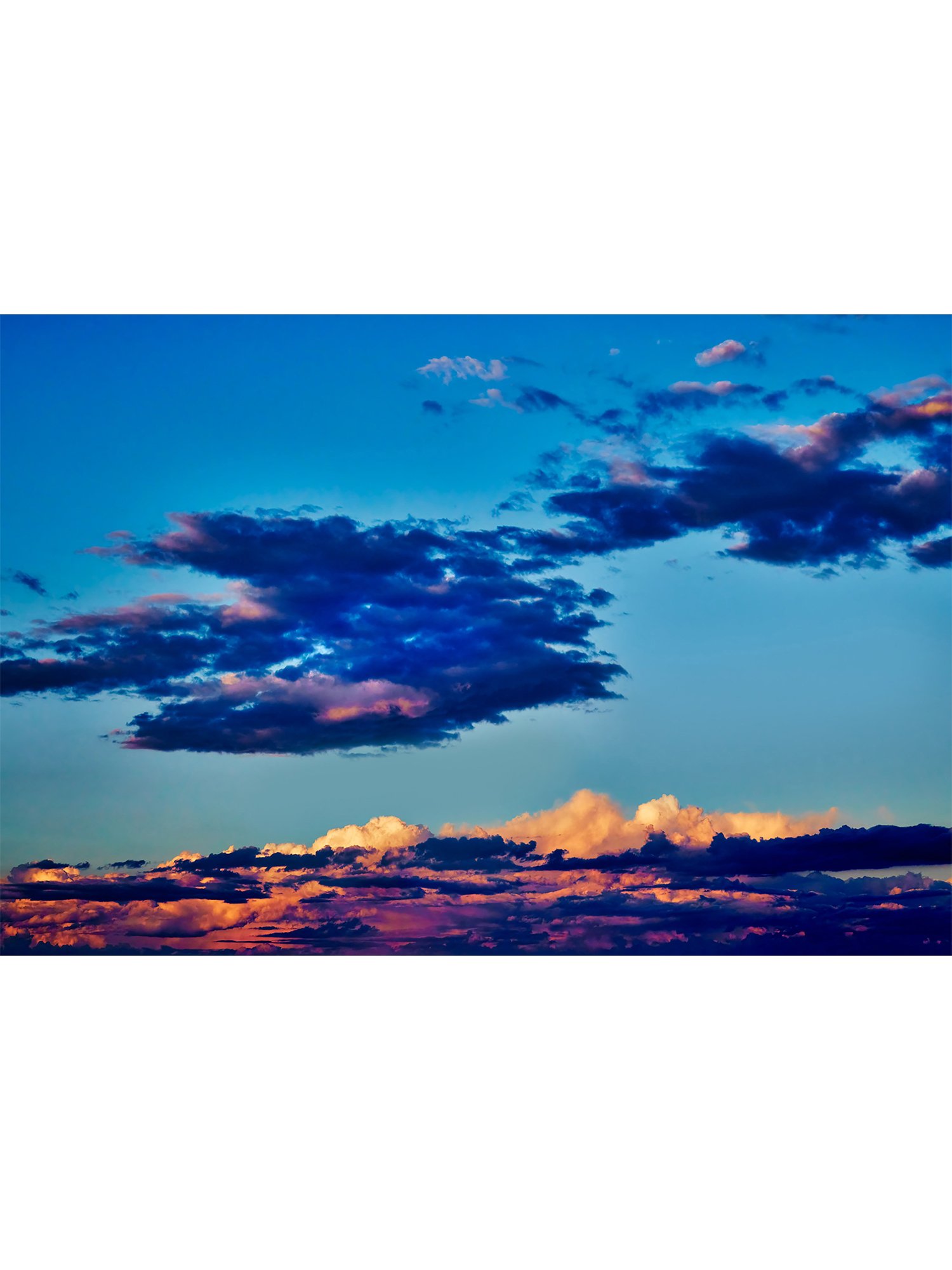 "Sky Sublime" photographic wall art, depicting richly colourful sunset clouds in hues of orange, magenta and purple, in a blue sky, at Pambula Beach.