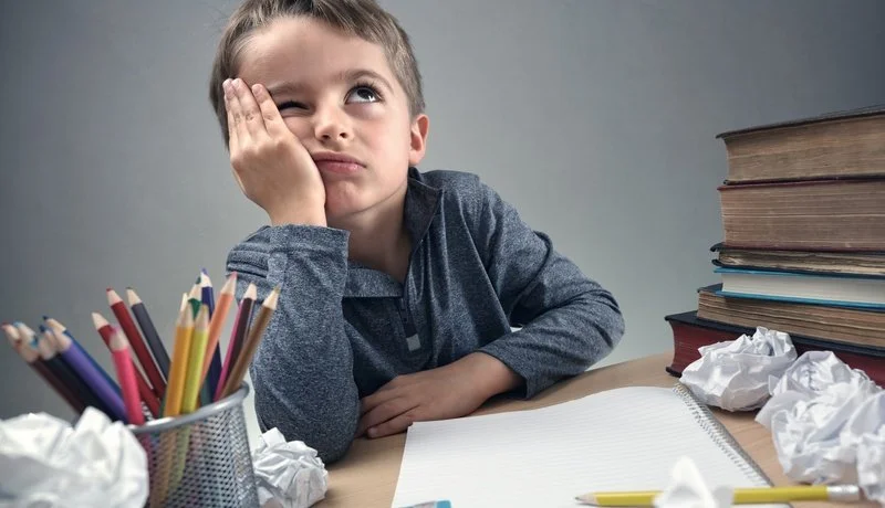 Bored-and-fed-boy-up-doing-his-homework-525336282_8508x5876.jpg