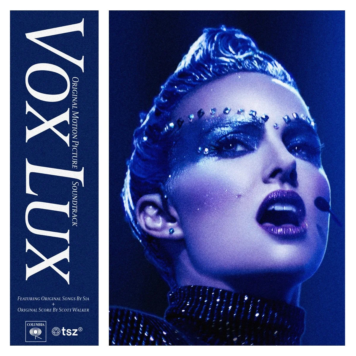 Cover of the "VOX LUX" soundtrack featuring a close-up of Natalie Portman in the staring role with bold makeup and rhinestones on her face, illuminated with blue lighting.