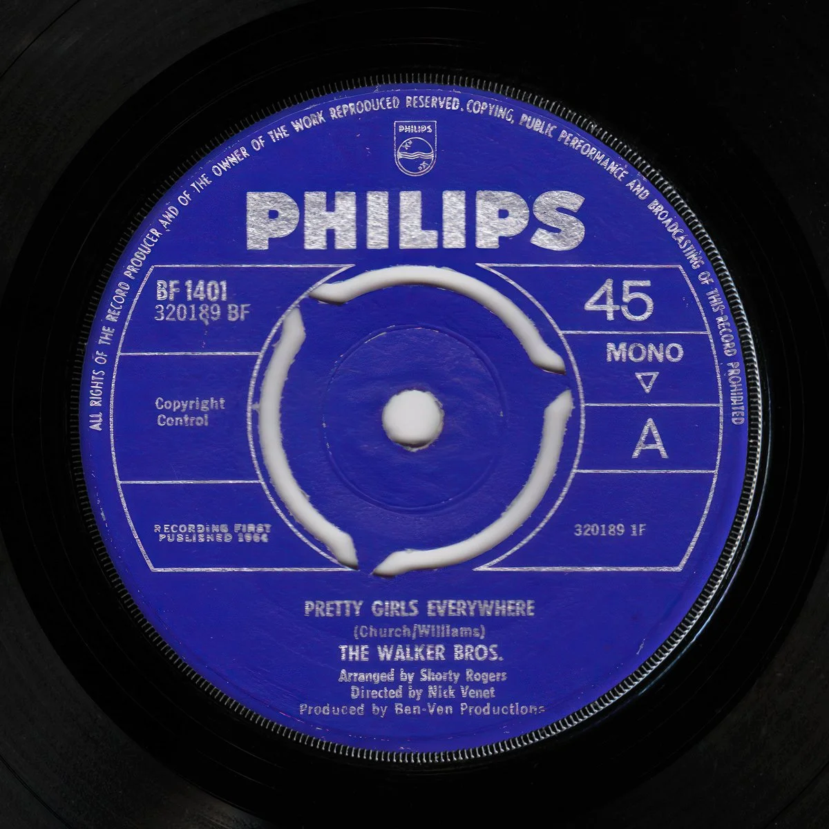 Close-up of a vintage Philips 45 RPM vinyl record label for 'Pretty Girls Everywhere' by The Walker Bros, arranged by Shorty Rogers.