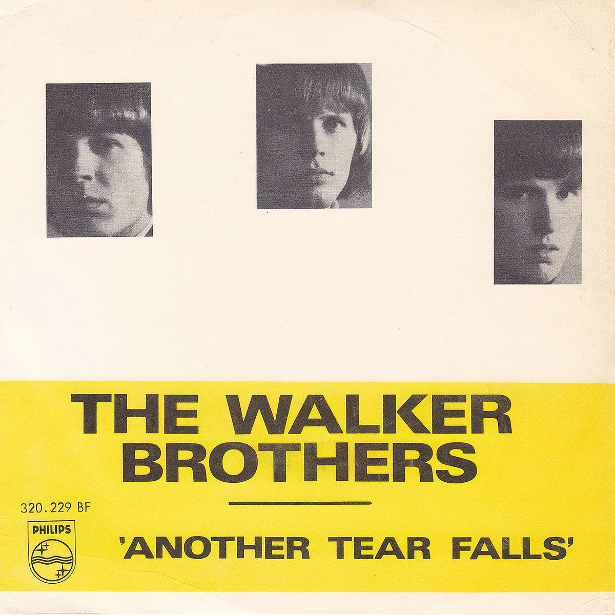 Cover for The Walker Brothers' single 'Another Tear Falls' featuring black and white portraits of three band members with a yellow section containing the band name and song title.