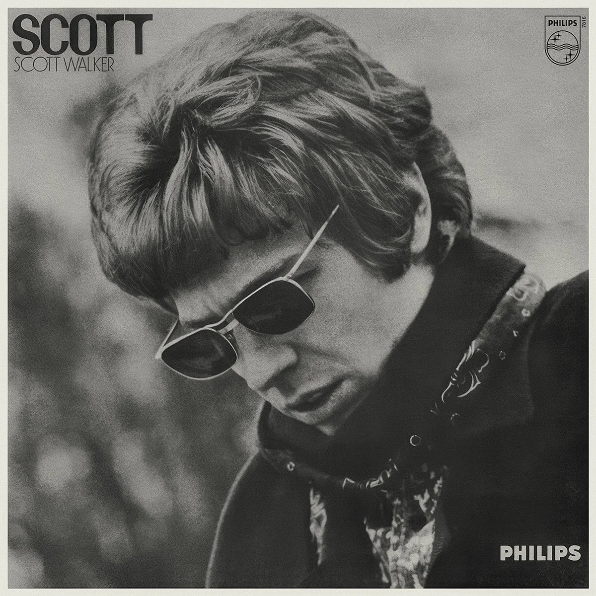 A black and white LP cover showing Scott Walker with styled hair and sunglasses, looking down. Text on the top left corner reads 'SCOTT' and 'SCOTT WALKER'. Top right corner features a logo with the word 'PHILIPS'.