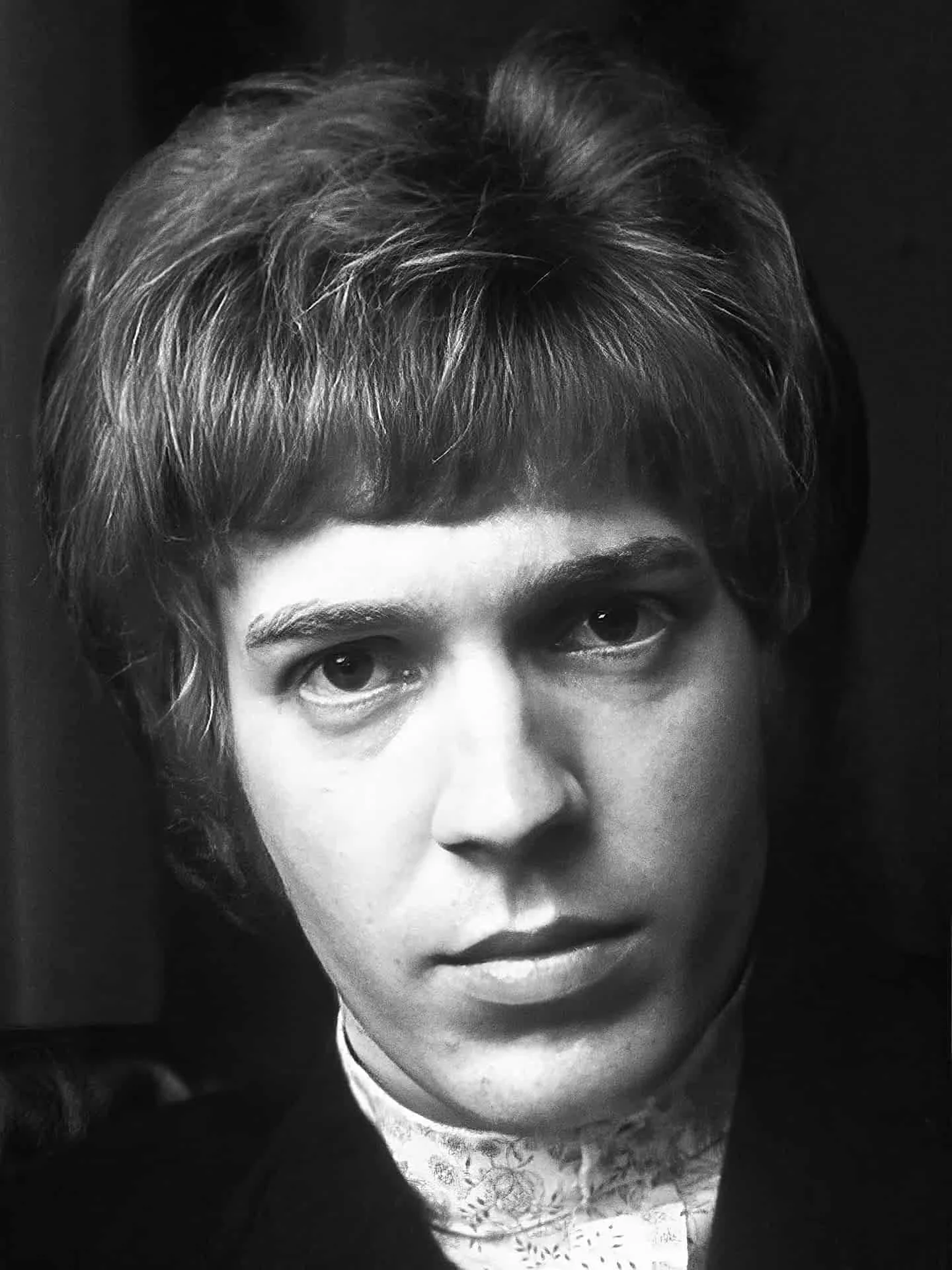 Black and white portrait of Scott Walker from the mid 1960's, wearing a lace-patterned top.