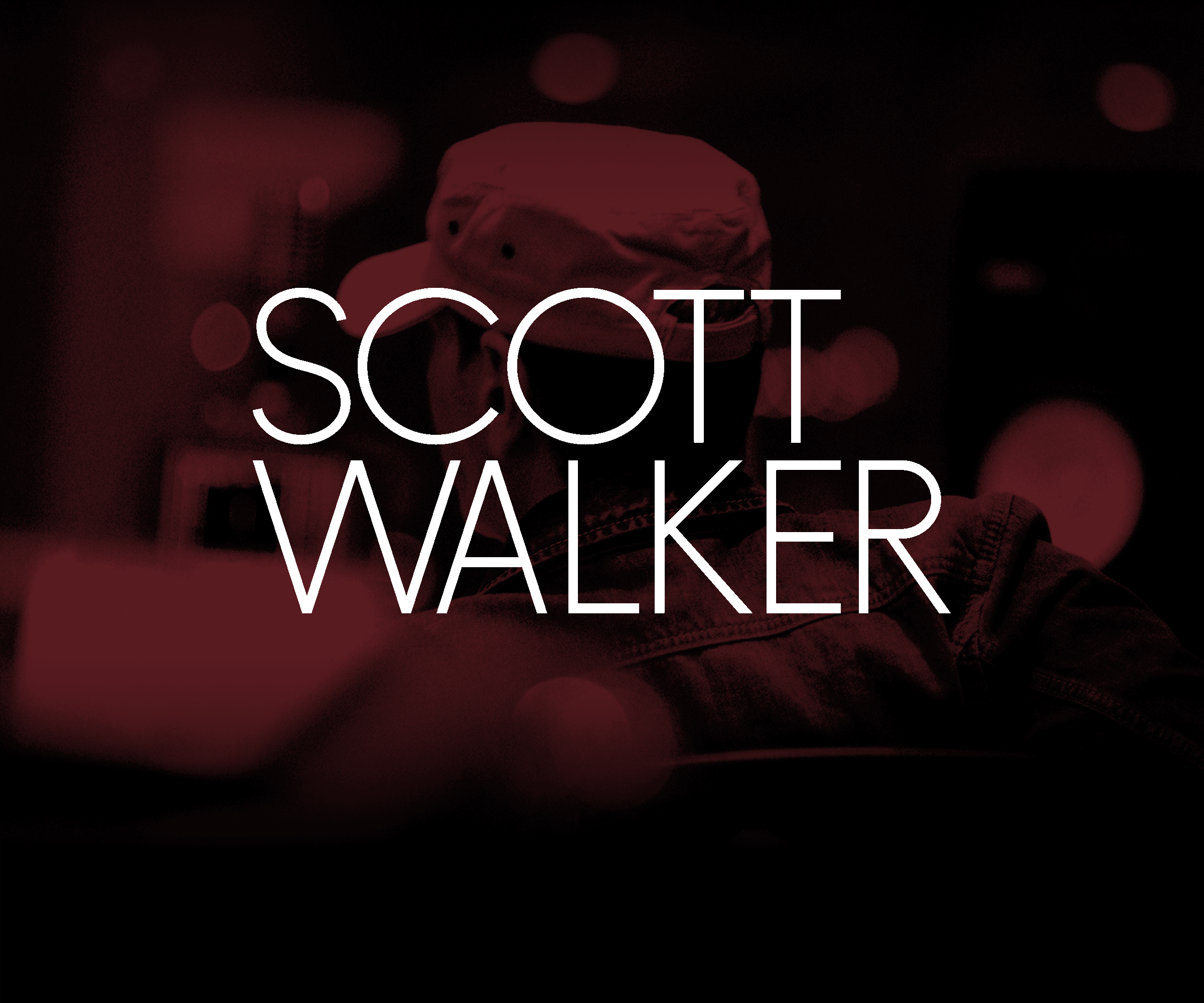Scott Walker wearing a cap, with his back to the camera, with a red tint overlay, standing in front of a dark background with red bokeh light effects. Text overlay reads "SCOTT WALKER".