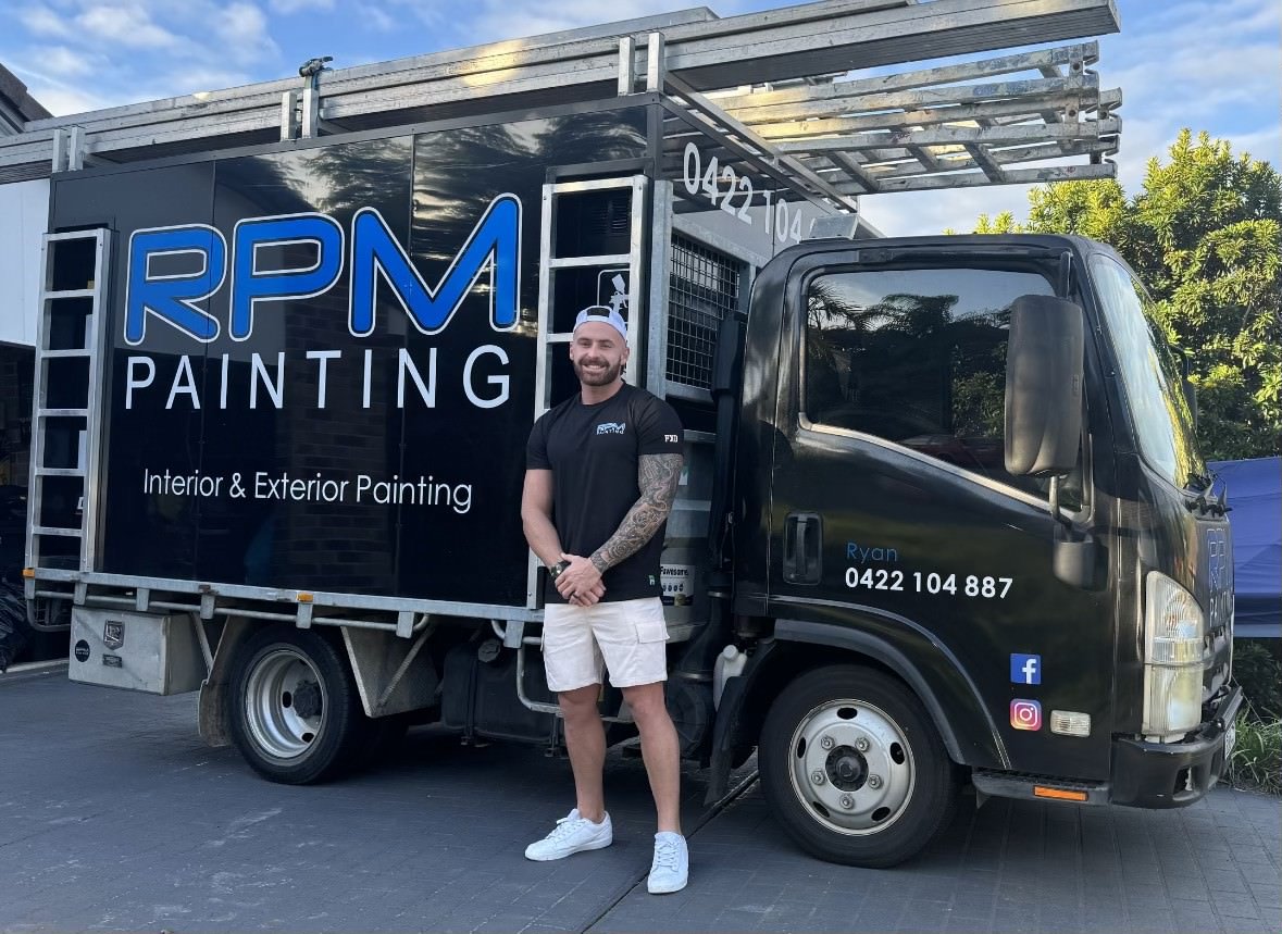 RPM Painting founder Ryan Martin in front of his branded truck.